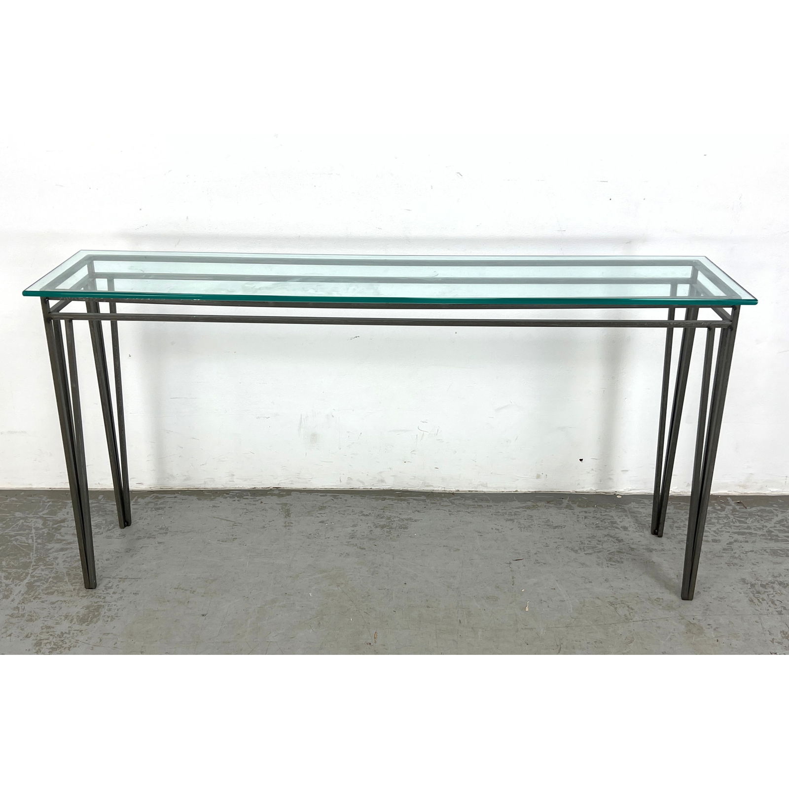 Steel and Glass Console Table. Angled legs.: Steel and Glass Console Table. Angled legs. Dimensions: Height: 30 inches, Width: 60 inches, Depth: 14 inches. --- - We offer curbside delivery for most items to NYC, Manhattan, Close Brooklyn, Hoboke