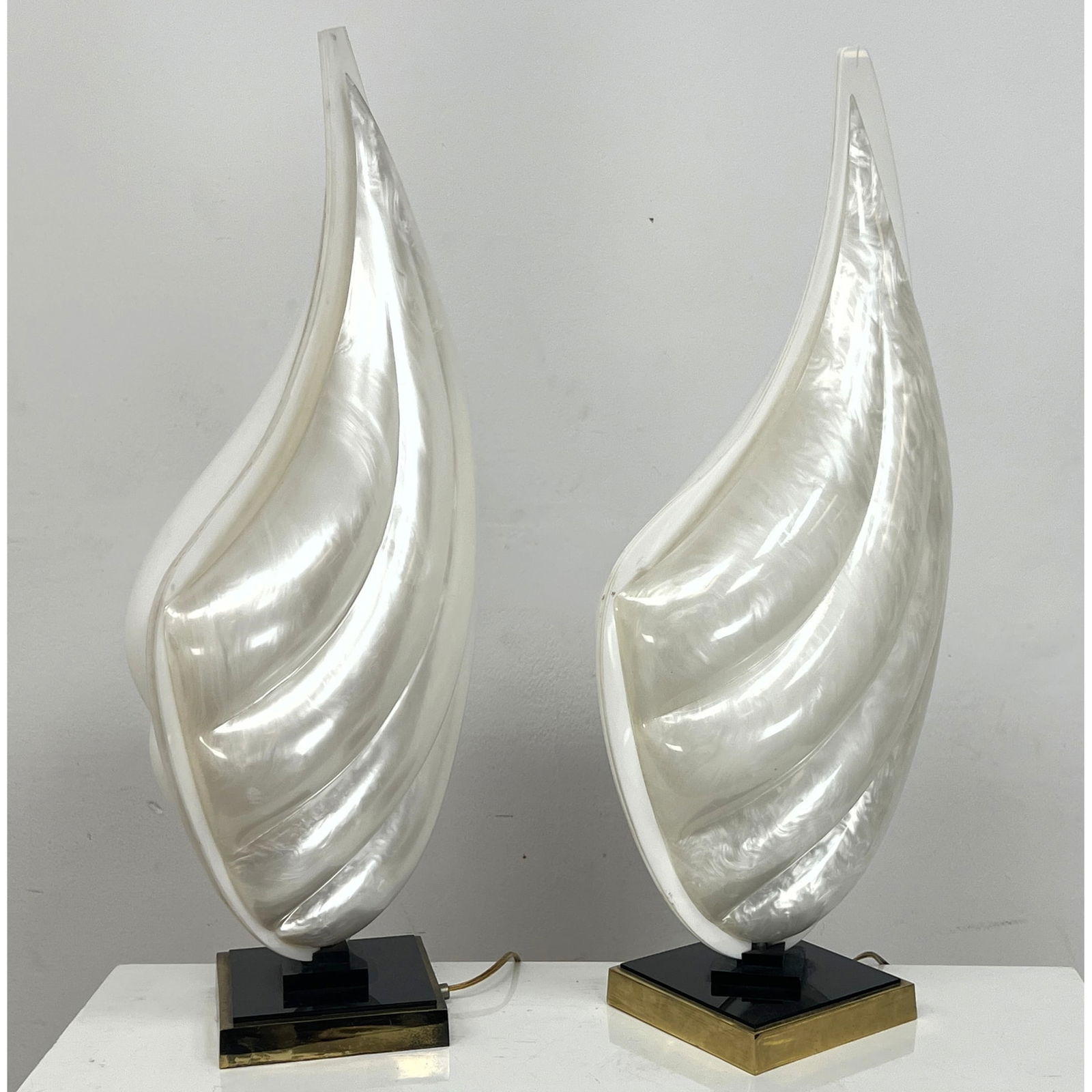 Pr ROUGIER Molded Acrylic "Sail" Form Table Lamps. Modernist French Lighting offers Warm Glow. Clam: Pr ROUGIER Molded Acrylic "Sail" Form Table Lamps. Modernist French Lighting offers Warm Glow. Clam Shell Motif. 1 side opaline other white. Has Rougier brass label. Dimensions: Height: 28 inches, Wid