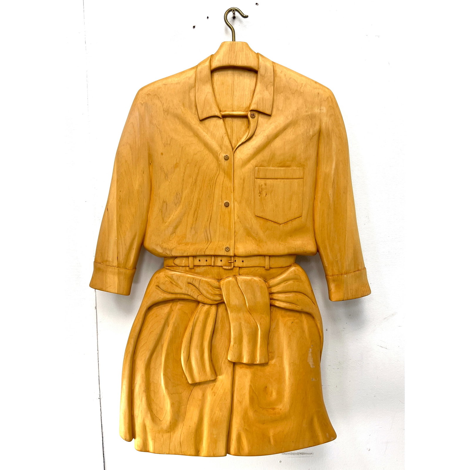Carved Trompe L'oeil" Relief Wood Sculpture. SY WENGROVITZ. Carved figural hanger holds Camp Shirt t: Carved Trompe L'oeil" Relief Wood Sculpture. SY WENGROVITZ. Carved figural hanger holds Camp Shirt tucked into shorts with belt. Artist Signed and Dated 1992. Dimensions: Height: 38 inches, Width: 23.