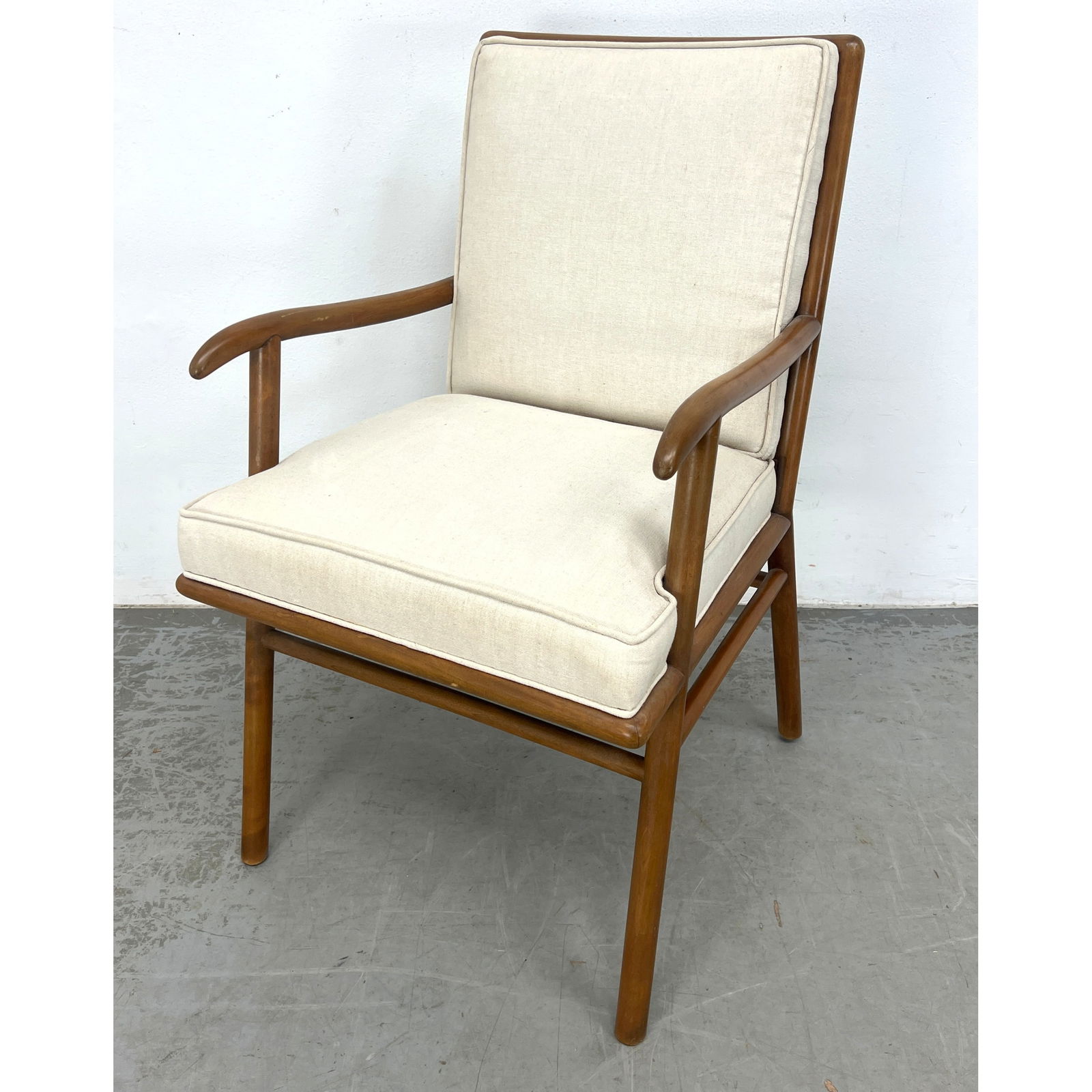 Robsjohn Gibbings style Modernist Walnut Arm Lounge Chair. Stylish Frame with cream fabric upholster: Robsjohn Gibbings style Modernist Walnut Arm Lounge Chair. Stylish Frame with cream fabric upholstery. Not marked. Dimensions: Height: 34.5 inches, Width: 20.5 inches, Depth: 22 inches. - Seat Height: