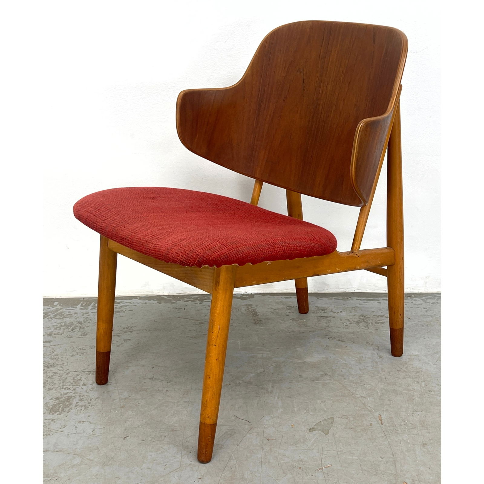Kofod Larsen Penguin Upholstered Chair. Wood Frame and Legs with Contrasting Darker Feet. Red Fabric: Kofod Larsen Penguin Upholstered Chair. Wood Frame and Legs with Contrasting Darker Feet. Red Fabric Seat. Dimensions: Height: 29.5 inches, Width: 21.5 inches, Depth: 26 inches. - Seat Height: 15.5 in