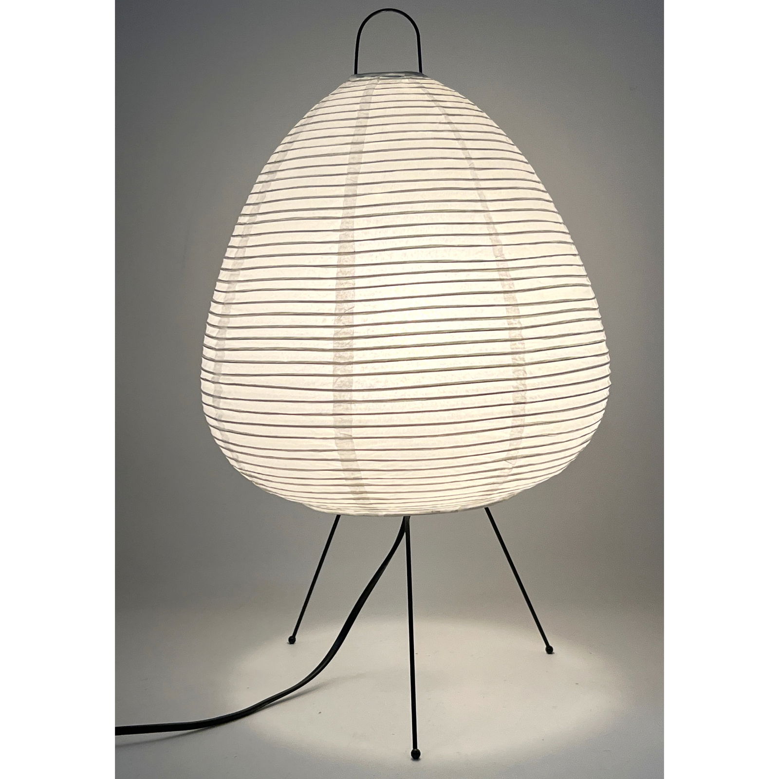 A Japanese Paper Akari style Table Lamp. Black Metal Wire Tripod Base supports beehive form paper la (1 of 11)