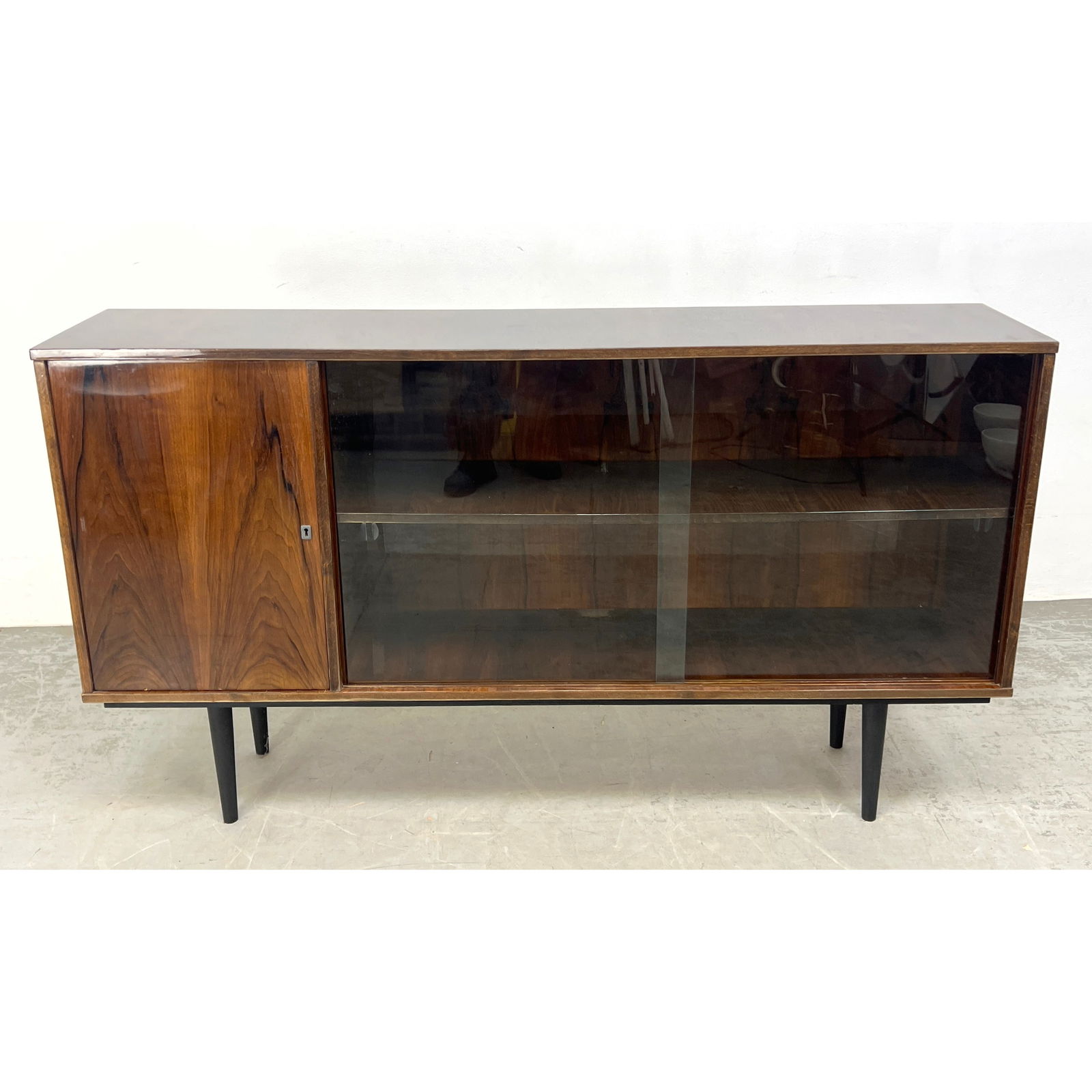 Mid Century Modern Polish Glass Sliding Door Credenza. Raised on Tall Peg Legs. Polish paper Label.: Mid Century Modern Polish Glass Sliding Door Credenza. Raised on Tall Peg Legs. Polish paper Label. Dimensions: Height: 35.25 inches, Width: 63.25 inches, Depth: 13.75 inches. --- - We offer curbside