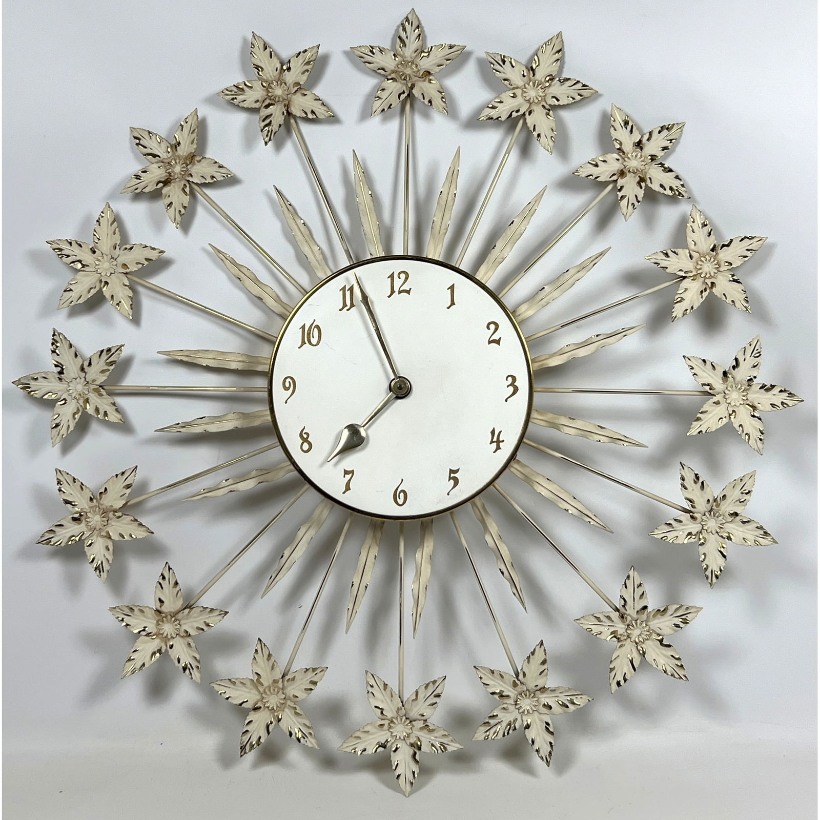 50s Vintage Starburst Style Wall Clock. Metal flowers.: 50s Vintage Starburst Style Wall Clock. Metal flowers. Dimensions: Height: 31 inches, Width: 31 inches, Depth: 2.5 inches. --- - We offer curbside delivery for most items to NYC, Manhattan, Close Broo