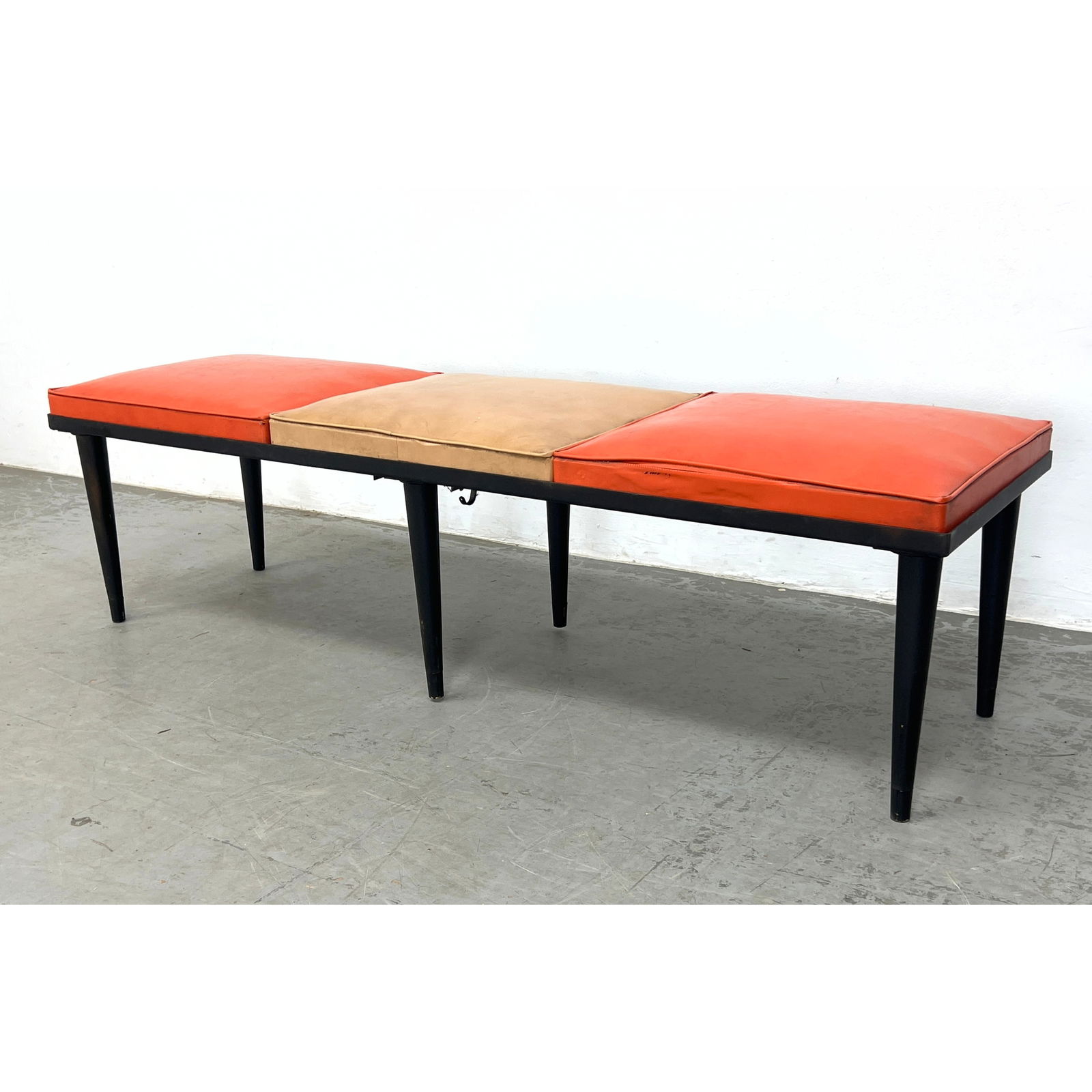 PENNANT Black Metal Three Seater Bench. Modernist Metal Frame supports 2 Orange and 1 Tan Cushions. (1 of 10)