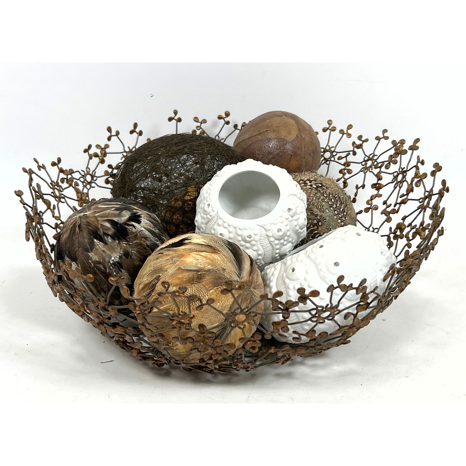 Delicate sculptural lacy metal bowl filled with Decorative Accents. 3 Ceramic Sea Urchin forms. Meta (1 of 11)