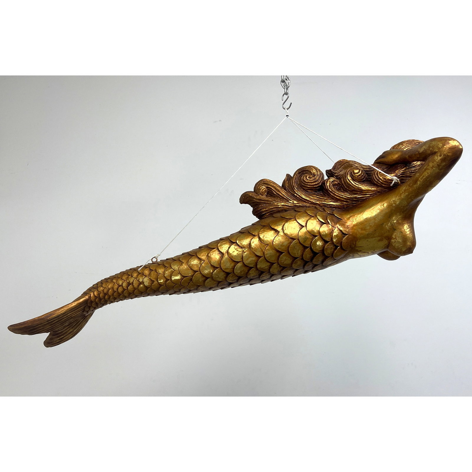 Hanging resin mermaid figurehead sculpture. Gilt style finish.: Hanging resin mermaid figurehead sculpture. Gilt style finish. Dimensions: Height: 49.5 inches, Width: 20.5 inches, Depth: 16 inches. --- - We offer curbside delivery for most items to NYC, Manhattan,