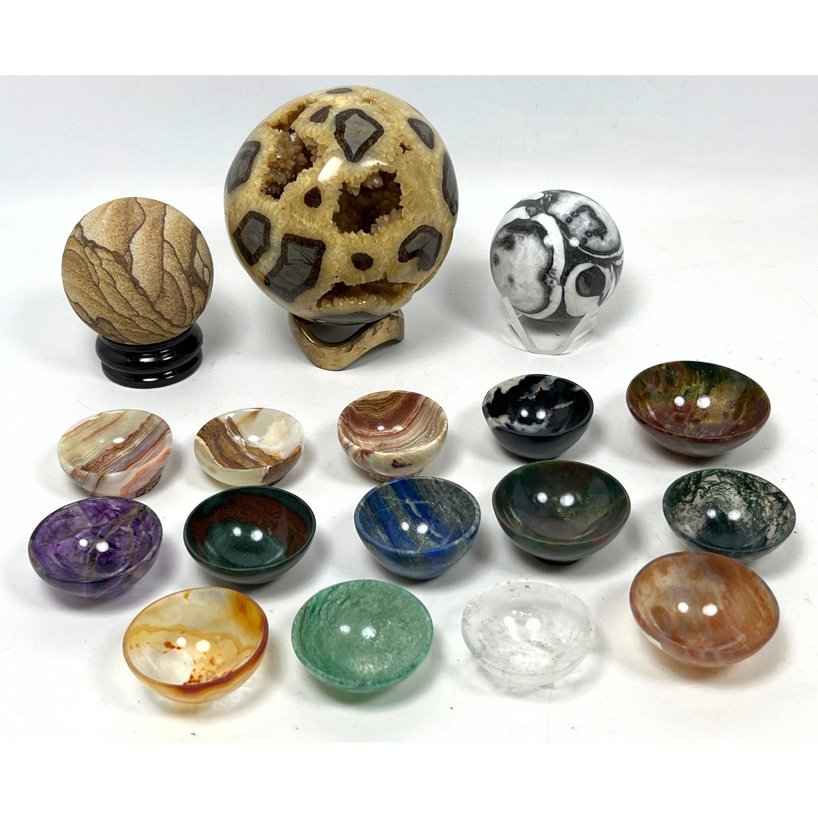 17pcs of polished stones incl 14 stone bowls and spheres. polished stone bowls, polished on the outs: 17pcs of polished stones incl 14 stone bowls and spheres. polished stone bowls, polished on the outside with crystals inside. polished stone about 3" in diameter that sits on a wooden base.? , "wonder