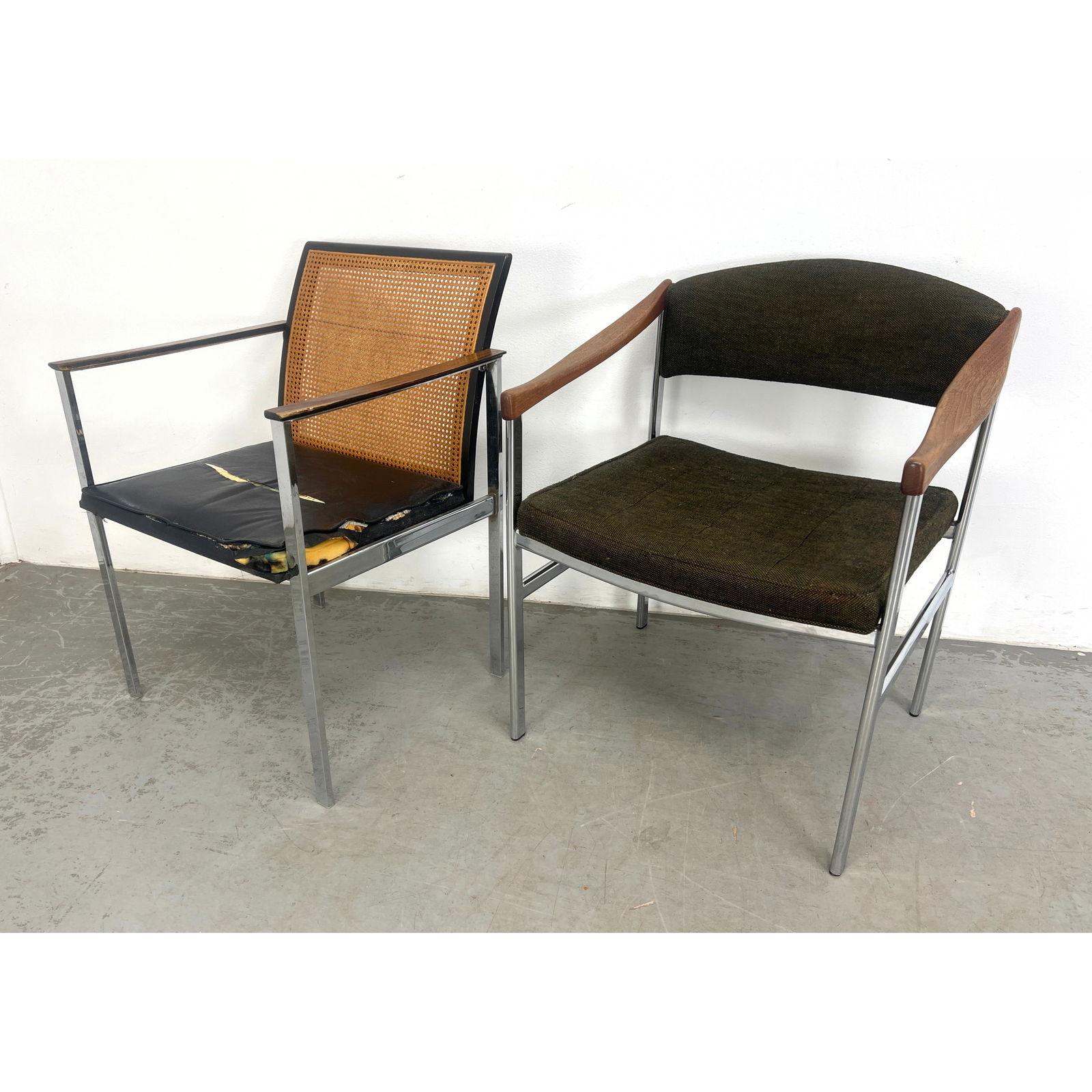 2pc modernist chrome armchairs with walnut arms. One cane back. Vintage mid century.: 2pc modernist chrome armchairs with walnut arms. One cane back. Vintage mid century. Dimensions: Height: 31 inches, Width: 22.5 inches, Depth: 19.5 inches. - Seat Height: 17 inches, W: 24.5 inches, D: