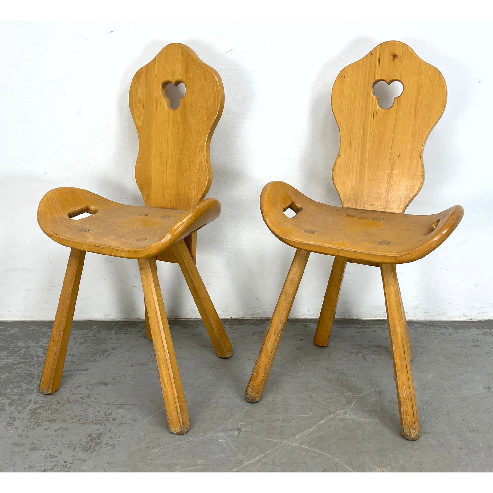 Pr Blond Wood French Chalet Chairs. Shaped Backs with cloverleaf cut outs. Bowed Seats have open han: Pr Blond Wood French Chalet Chairs. Shaped Backs with cloverleaf cut outs. Bowed Seats have open handles. Dimensions: Height: 34 inches, Width: 19 inches, Depth: 18 inches. - Seat Height: 17.5 inches 