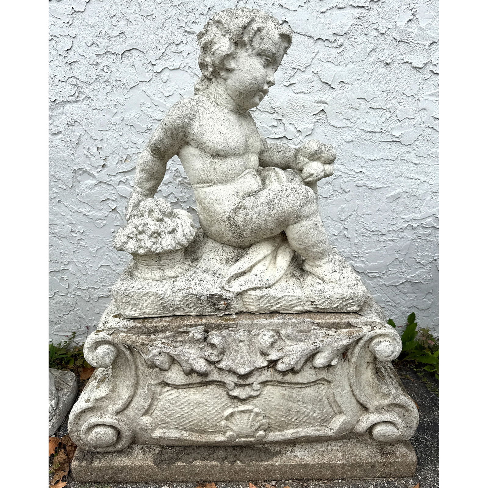 2 Part Cast stone garden statue depicting a seated putti, likely an allegory of Autumn. Outdoor Gard (1 of 9)