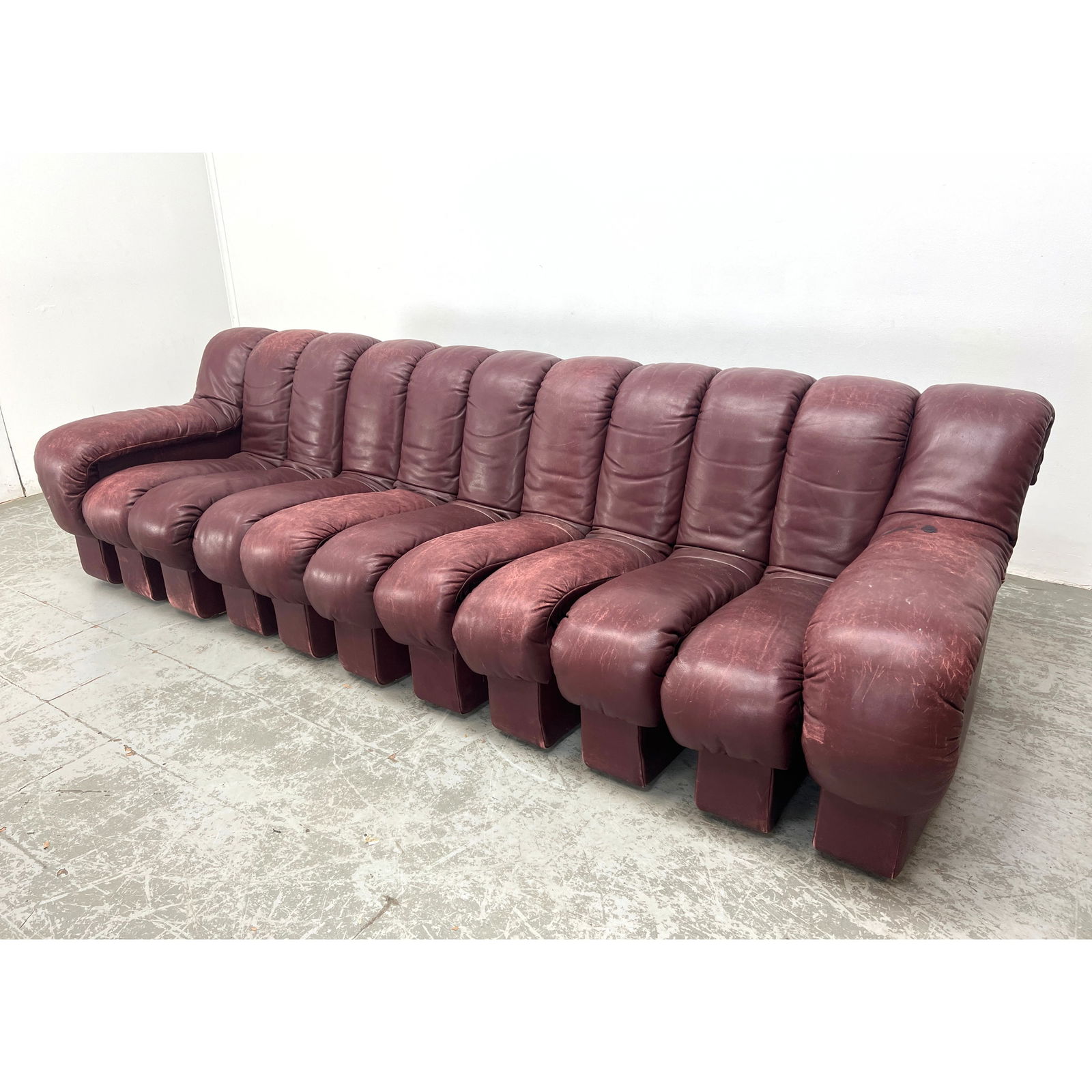 11 Section De Sede by UELI BERGER Non-Stop Sofa. De Sede. Leather. Stendig label. Heavily Rotten bet: 11 Section De Sede by UELI BERGER Non-Stop Sofa. De Sede. Leather. Stendig label. Heavily Rotten between sections need restoration. Dimensions: Height: 27 inches, Width: 114 inches, Depth: 40 inches.