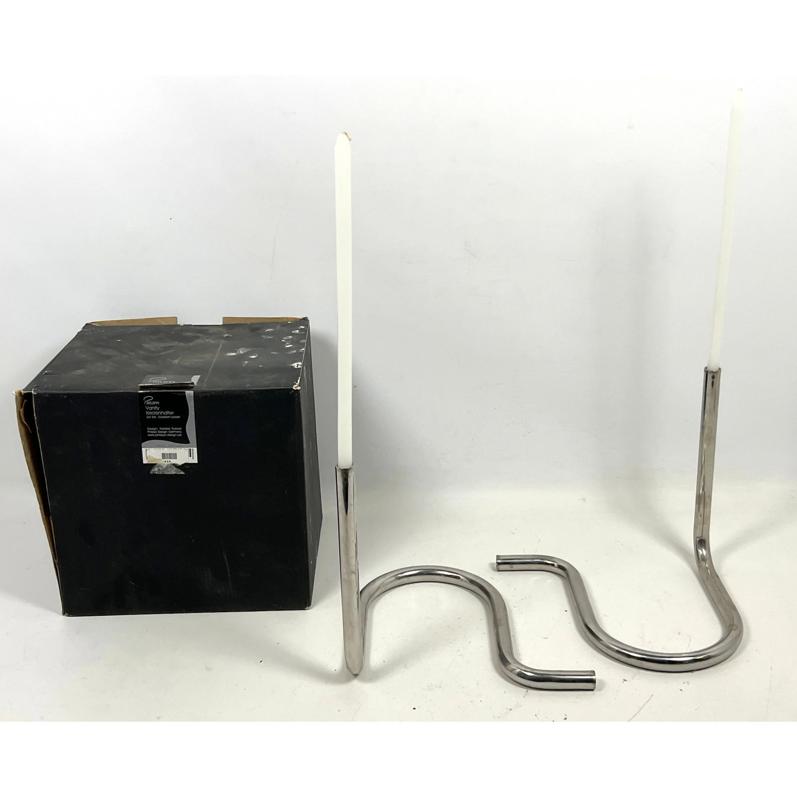 Pair German Stainless Steel candlesticks by Natalie Rutard for Phillippi Design: Pair German Stainless Steel candlesticks by Natalie Rutard for Phillippi Design Dimensions: Height: 8.5 inches, Width: 8.75 inches, Depth: 7.75 inches. --- US Packing and Shipping charge: In house shi