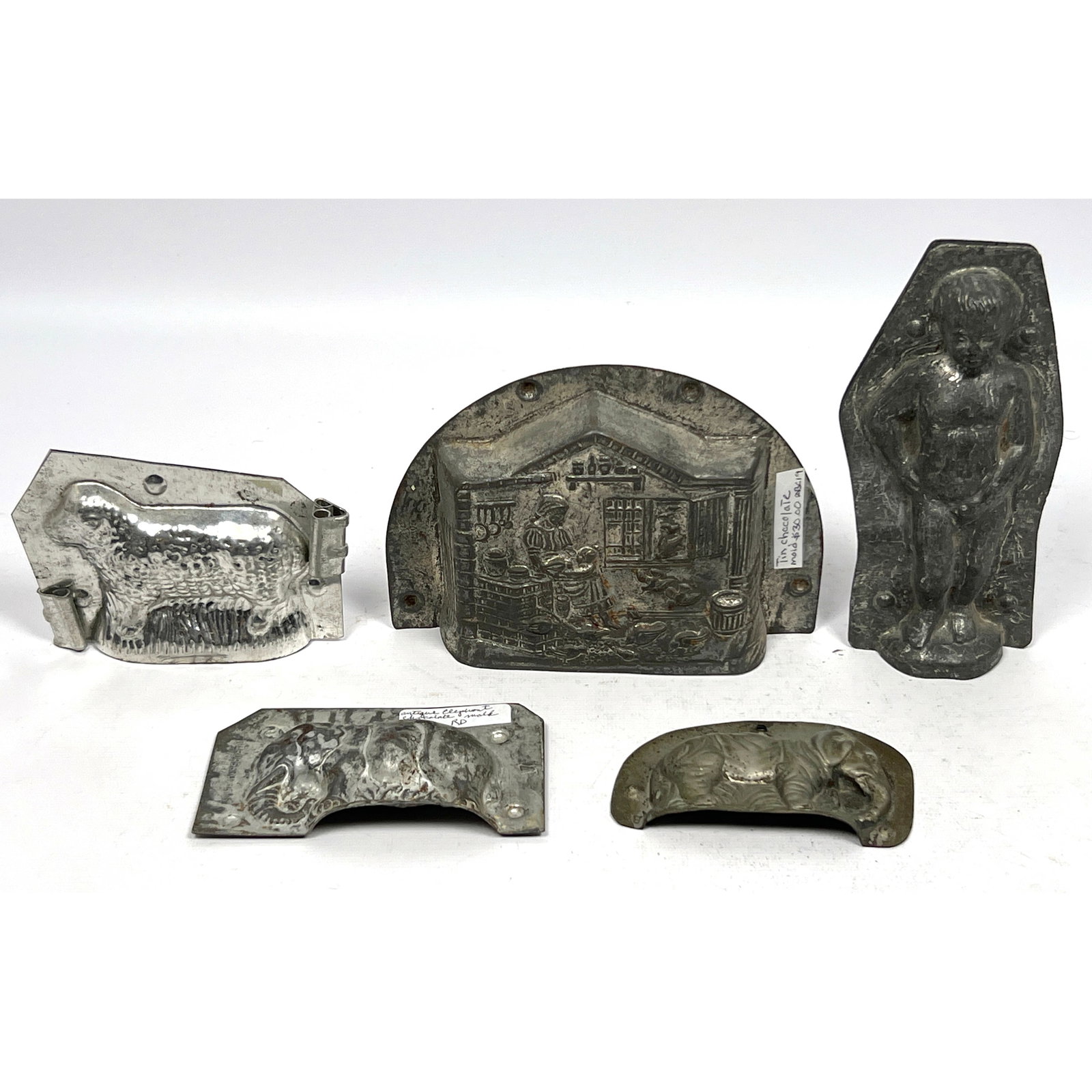 5pc Vintage Chocolate Confectionary Molds. 1) Sheep. 2) Nude Boy. 3) Interior Scene. Two One Piece E: 5pc Vintage Chocolate Confectionary Molds. 1) Sheep. 2) Nude Boy. 3) Interior Scene. Two One Piece Elephant Molds. Dimensions: Height: 4.5 inches, Width: 6.25 inches, Depth: 1 inches. --- US Packing a