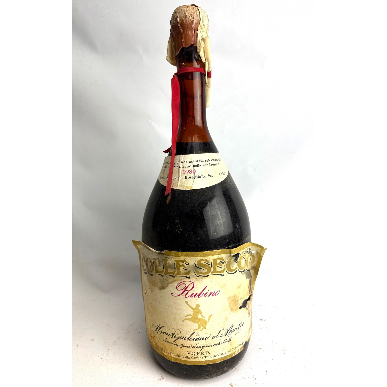 Vintage Italian Montepulciano d'Abruzzo red wine, 1980 vintage, labeled 'COLLE SECCO Rubino' and bot: Vintage Italian Montepulciano d'Abruzzo red wine, 1980 vintage, labeled 'COLLE SECCO Rubino' and bottled by Cantina Tollo. Dimensions: Height: 19 inches, Width: 6 inches, Depth: 6 inches. --- - We off