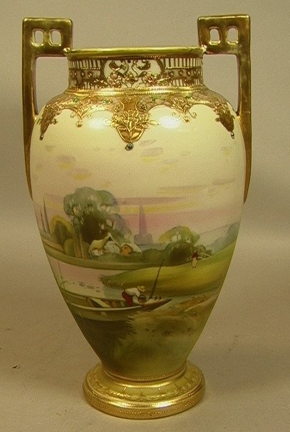NIPPON Hand Painted Porcelain Handled Vase. Gilt: NIPPON Hand Painted Porcelain Handled Vase. Gilt architectural handles. Scenic Landscape Decoration of fisherman in boat. country scene behind him. Raised gilt paint trim & decoration. Marked. -- Dime