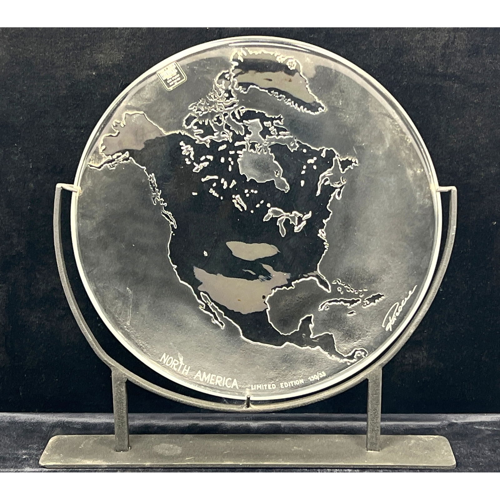RIEDEL Austrian Lead Crystal Plate. Relief Image of North American Continent. Artist Signed. Marked: RIEDEL Austrian Lead Crystal Plate. Relief Image of North American Continent. Artist Signed. Marked North America Limited Edition 150/53. On stand. Reidel Label. Dimensions: Height: 16 inches, Width: