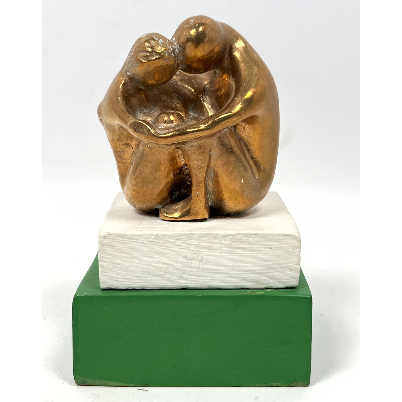 Abstract Miniature Metal Figural Sculpture. Seated Couple embracing. Not marked. Wood base: Abstract Miniature Metal Figural Sculpture. Seated Couple embracing. Not marked. Wood base Dimensions: Height: 5 inches, Width: 3.25 inches, Depth: 3.25 inches. --- US Packing and Shipping charge: In