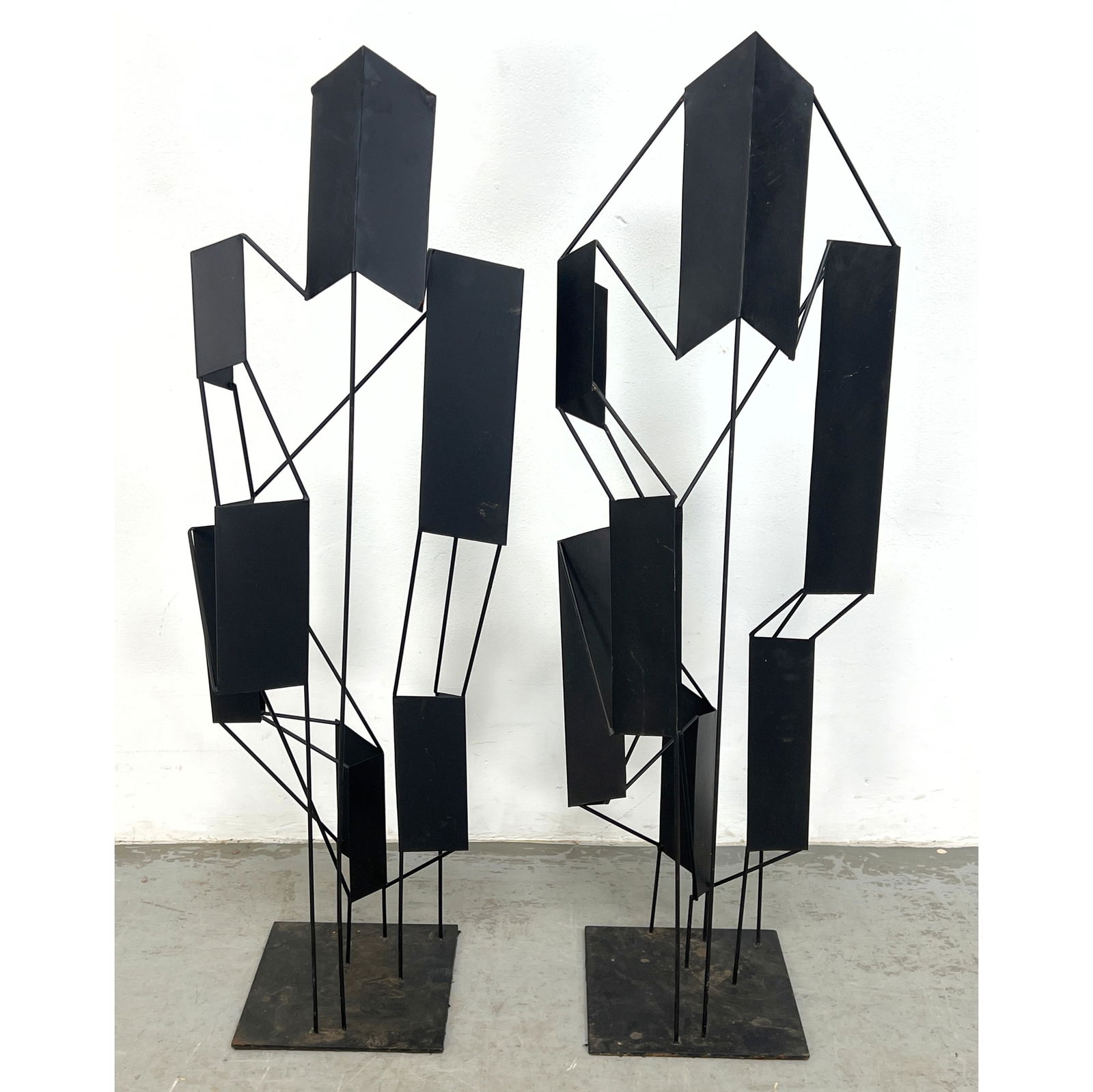 2pc Black Modernist Metal Sculptures. Black upright rods support Flat and Angled Metal Panels. Black: 2pc Black Modernist Metal Sculptures. Black upright rods support Flat and Angled Metal Panels. Black Steel Bases. Dimensions: Height: 45 inches, Width: 15 inches, Depth: 11 inches. --- - We offer curb