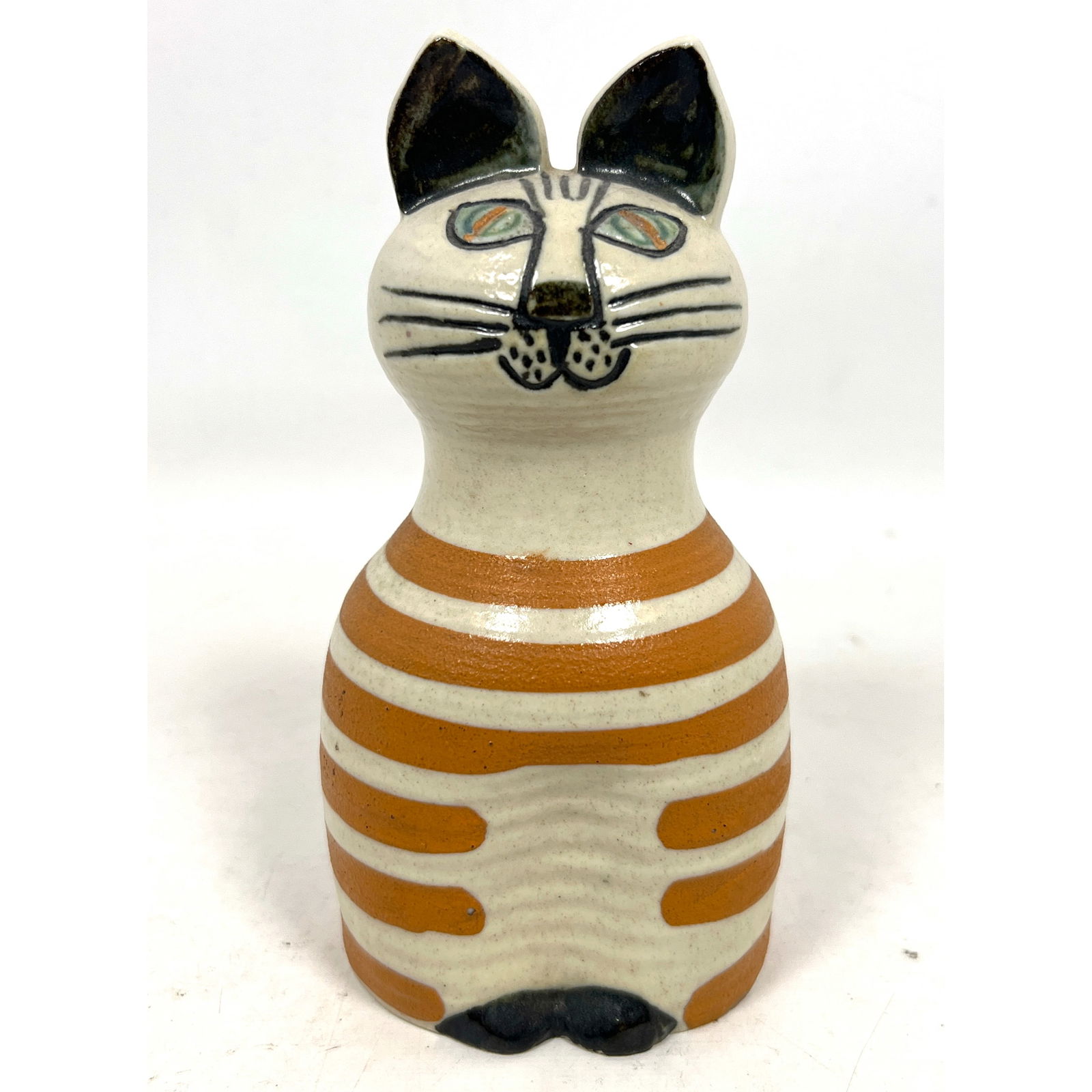 LISA LARSON for GUSTAVSBERG Cat Sculpture. Glazed Off White Stoneware with Orange Brown Stripes. Tra: LISA LARSON for GUSTAVSBERG Cat Sculpture. Glazed Off White Stoneware with Orange Brown Stripes. Trapp Series. Paper Label. Impressed Gustavsberg Mark. Dimensions: Height: 7 inches, Width: 3.5 inches,