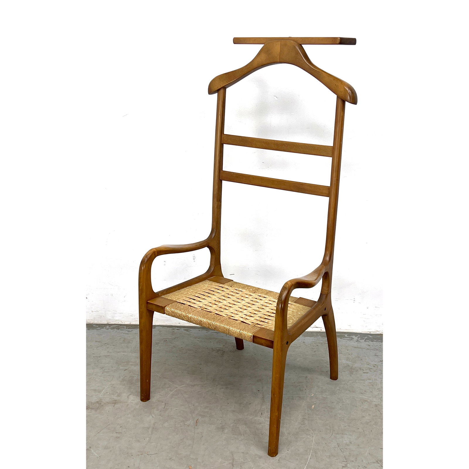 Amcrest mid-century modern gentleman's valet chair featuring a sculpted wood frame and a woven natur: Amcrest mid-century modern gentleman's valet chair featuring a sculpted wood frame and a woven natural cord seat. Dimensions: Height: 44.5 inches, Width: 22 inches, Depth: 20 inches. - Seat Height: 13