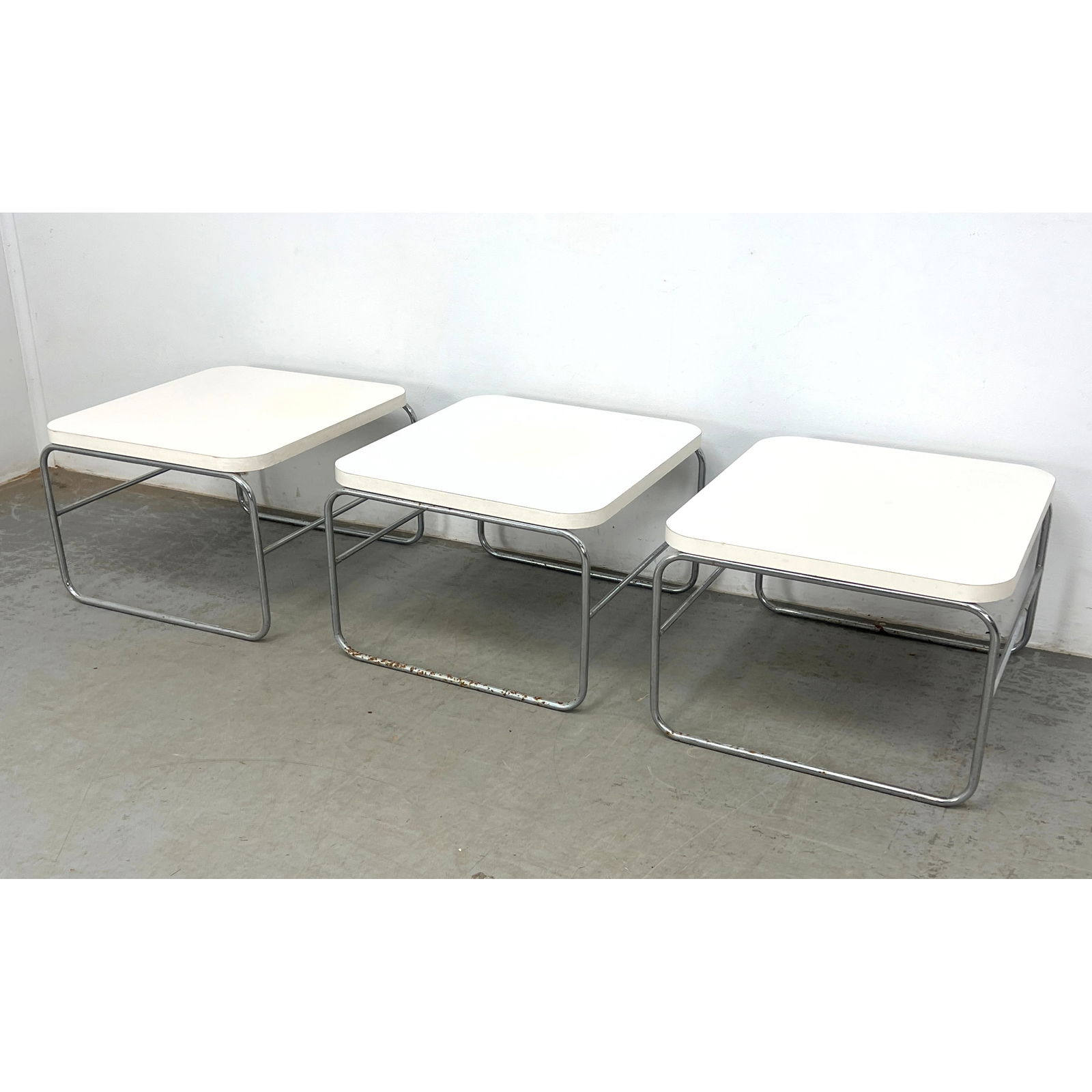 Set 3 Artoplex Side Tables. Chrome and white laminate.: Set 3 Artoplex Side Tables. Chrome and white laminate. Dimensions: Height: 16 inches, Width: 22.5 inches, Depth: 24.5 inches. ---