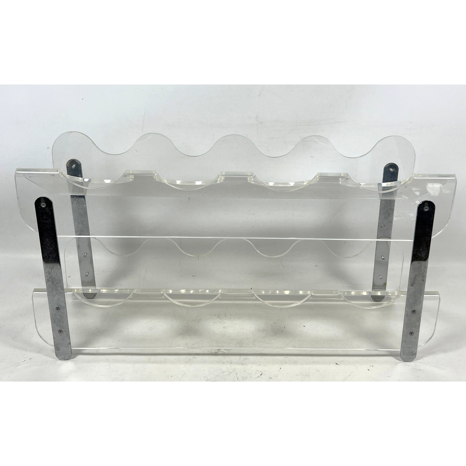 Modernist Lucite and Chrome Frame Wine Rack. Holds Eight Bottles.: Modernist Lucite and Chrome Frame Wine Rack. Holds Eight Bottles. Dimensions: Height: 12.5 inches, Width: 24 inches, Depth: 7.5 inches. ---