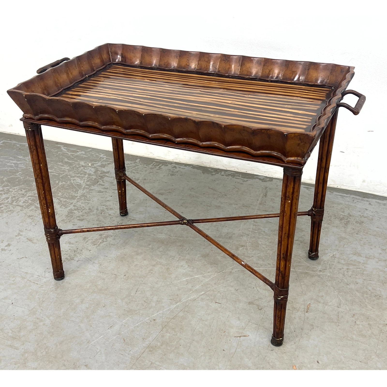 2pc Butler's Tray Side Table. Maitland Smith style. Scalloped wood frame removable tray has bamboo t: 2pc Butler's Tray Side Table. Maitland Smith style. Scalloped wood frame removable tray has bamboo theme surface. Wrapped Rattan Legs with X Stretcher. Dimensions: Height: 22.5 inches, Width: 32
