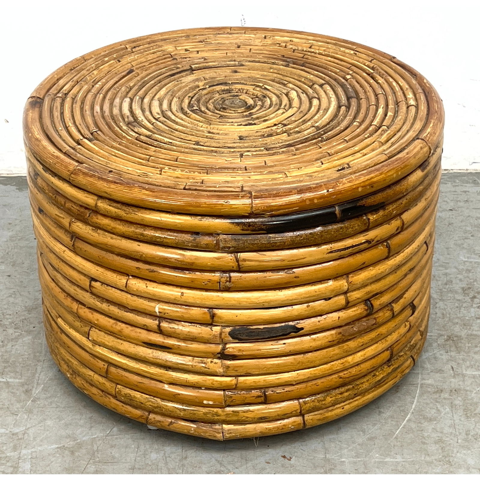 Vintage coastal style round drum table or ottoman featuring a coiled reed construction: Vintage coastal style round drum table or ottoman featuring a coiled reed construction Dimensions: Height: 15 inches, Width: 22 inches, Depth: 22 inches. ---