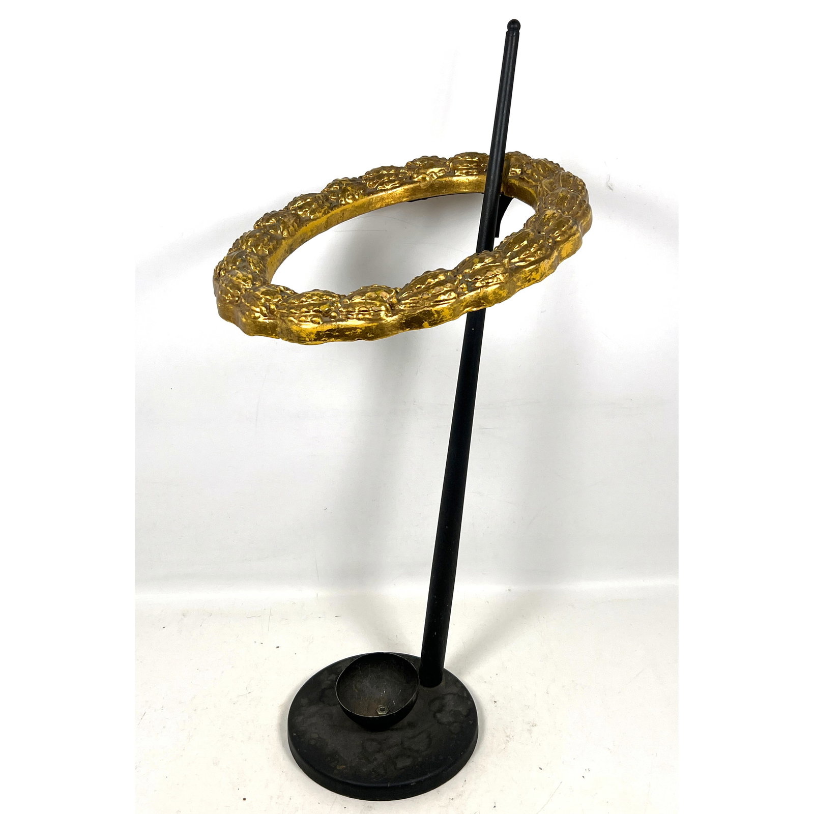 Floor-standing umbrella or cane stand featuring a black-painted metal support pole and circular base: Floor-standing umbrella or cane stand featuring a black-painted metal support pole and circular base. Dimensions: Height: 31.5 inches, Width: 14 inches, Depth: 16 inches. ---
