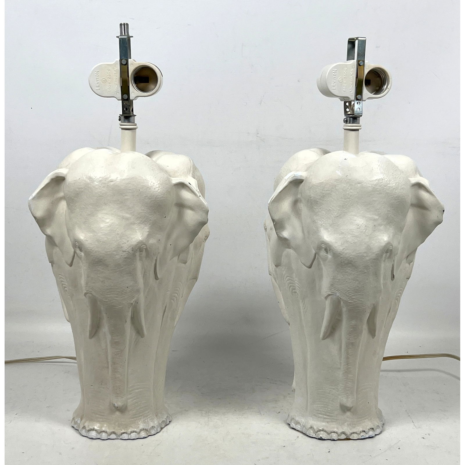 Pr Elephant form Figural Table Lamps. Cast metal forms painted white. Each has two figures.: Pr Elephant form Figural Table Lamps. Cast metal forms painted white. Each has two figures. Dimensions: Height: 17 inches, Width: 8 inches, Depth: 8 inches. --- US Packing and Shipping charge: In hous
