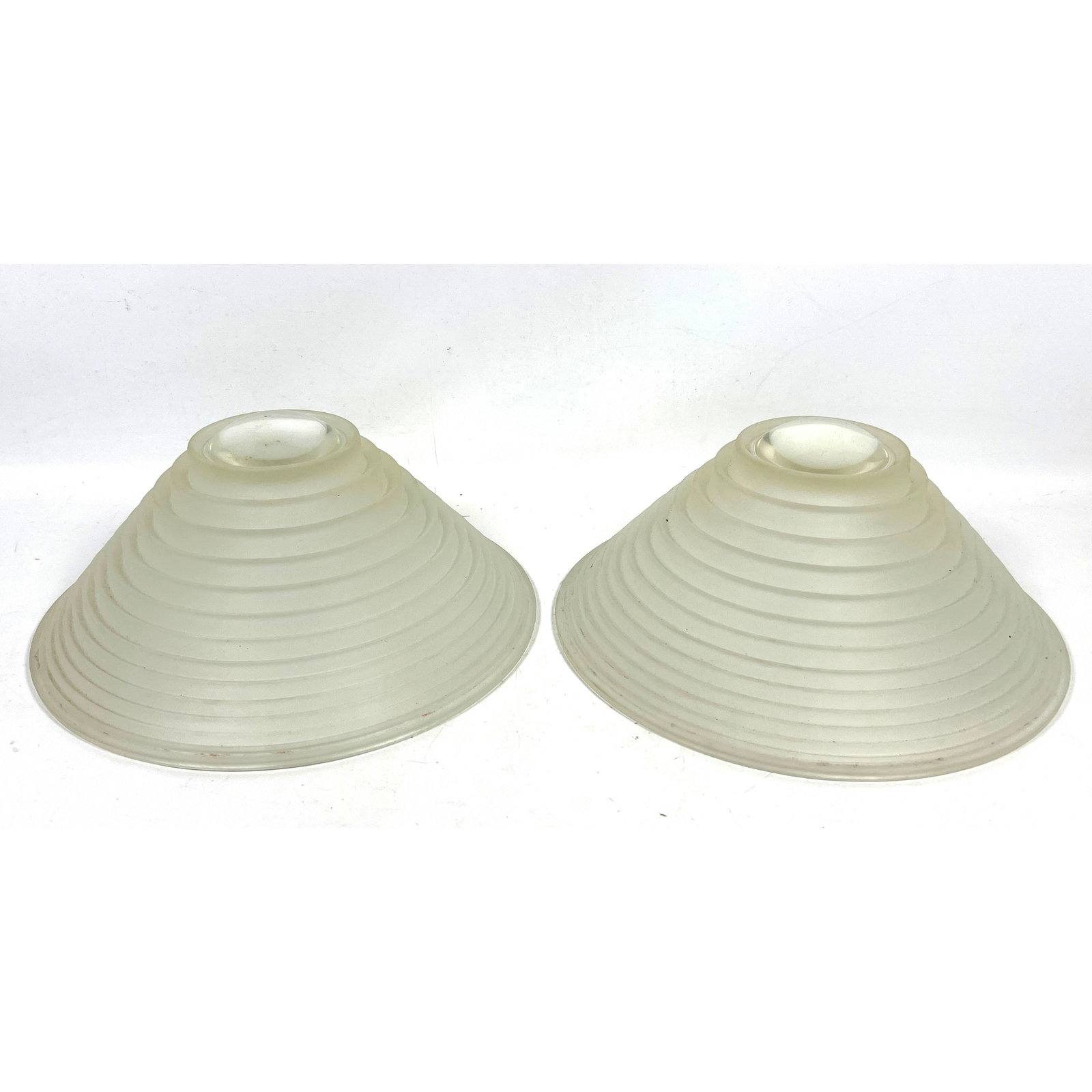 Pair of light shades designed in the Art Deco style.: Pair of light shades designed in the Art Deco style. Dimensions: Height: 7 inches, Width: 15 inches, Depth: 15 inches. ---