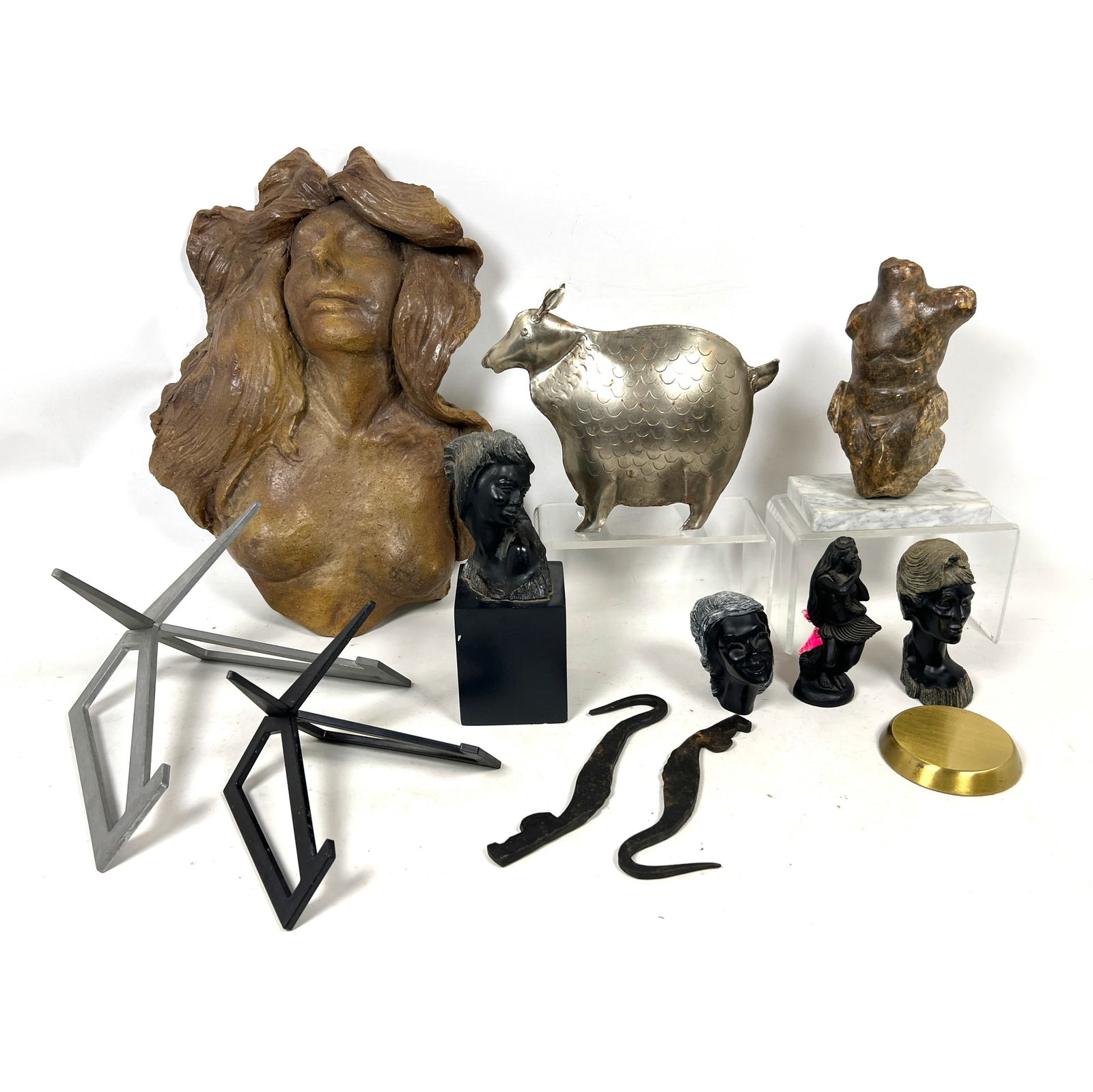 Assorted Shelf lot. Carved Busts. Metal Animal. two Paul Goddard display stands. and more: Assorted Shelf lot. Carved Busts. Metal Animal. two Paul Goddard display stands. and more Dimensions: Height: 18 inches, Width: 14 inches, Depth: 7 inches. ---