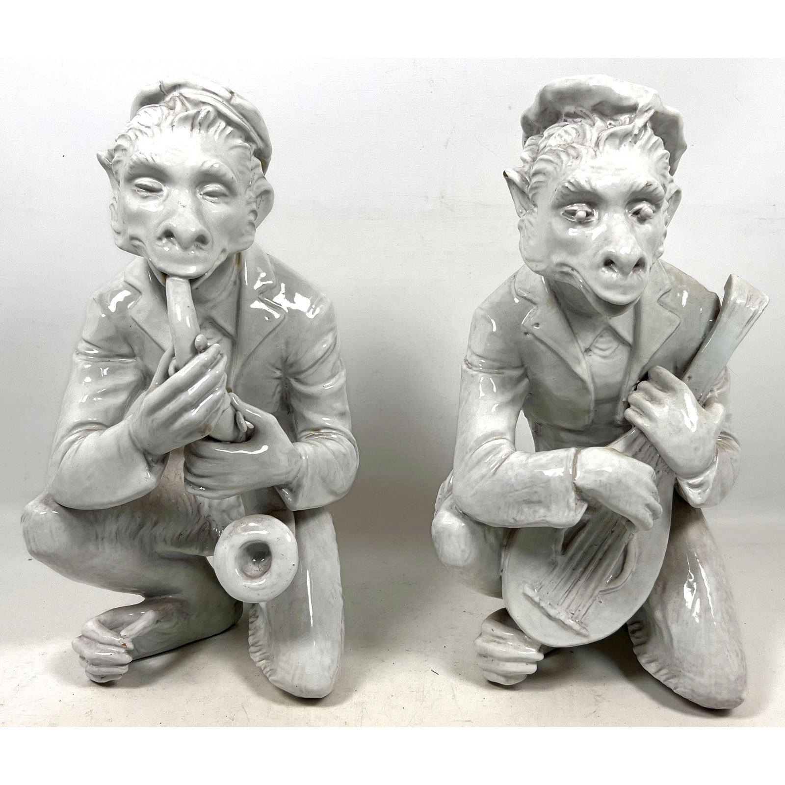 Pair Italian glazed ceramic figurines depicting anthropomorphic monkeys as musicians. sculptures.: Pair Italian glazed ceramic figurines depicting anthropomorphic monkeys as musicians. sculptures. Dimensions: Height: 15.5 inches, Width: 9 inches, Depth: 11 inches. ---