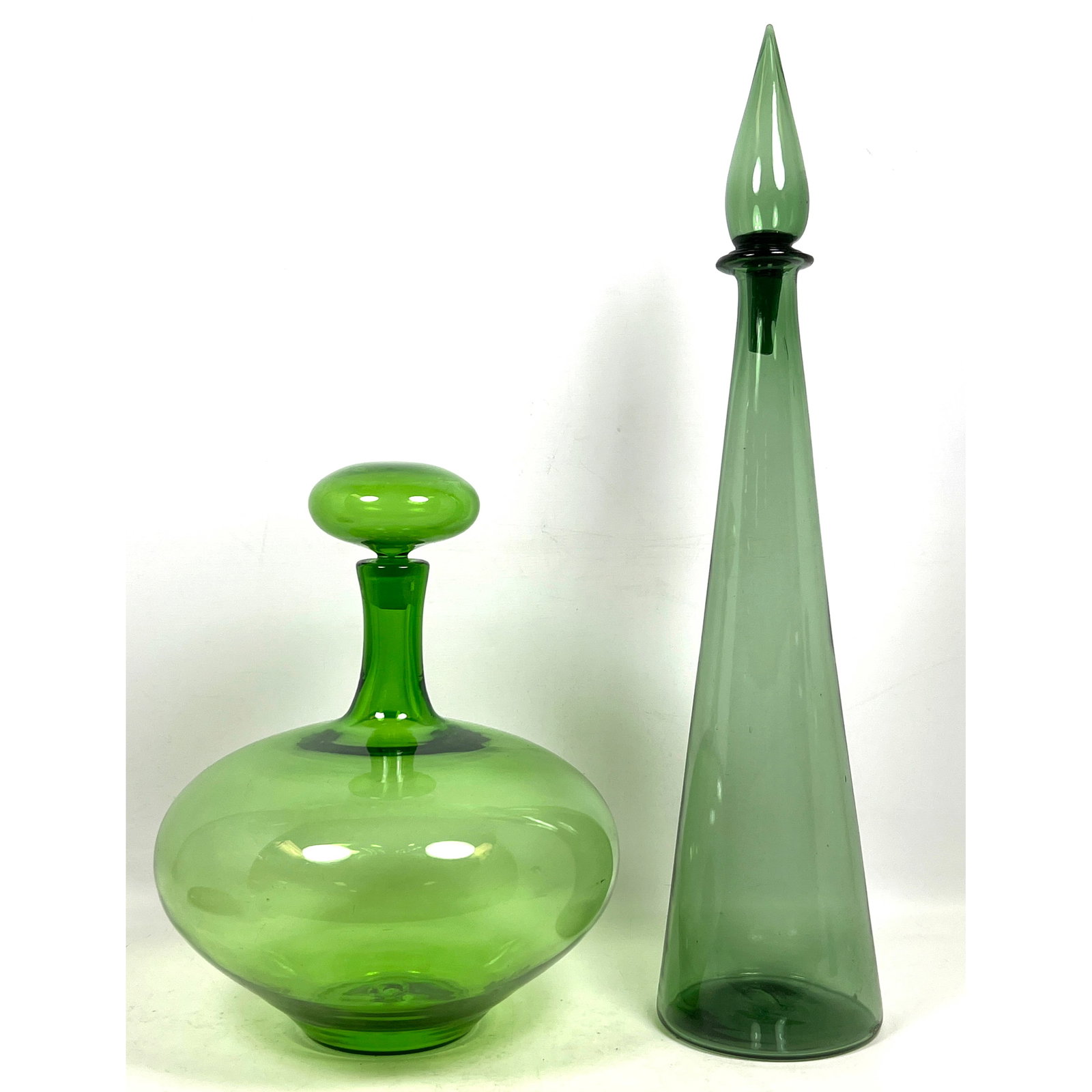 Two hand-blown glass decanters with stoppers. Blenko and Italian. No Markings.: Two hand-blown glass decanters with stoppers. Blenko and Italian. No Markings. Dimensions: Height: 25 inches, Width: 5.5 inches, Depth: 5.5 inches. - Additional Dimensions: Smaller H: 14.5