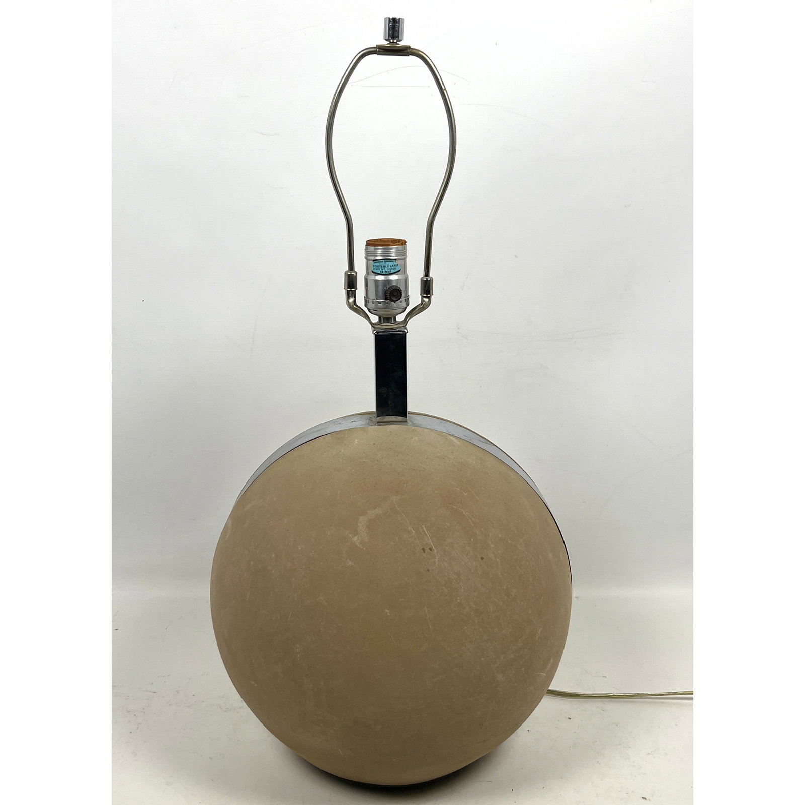 Mid-Century Modern table lamp featuring a large spherical ceramic base with a textured matte tan fin: Mid-Century Modern table lamp featuring a large spherical ceramic base with a textured matte tan finish. Dimensions: Height: 23.5 inches, Width: 10 inches, Depth: 10 inches. ---