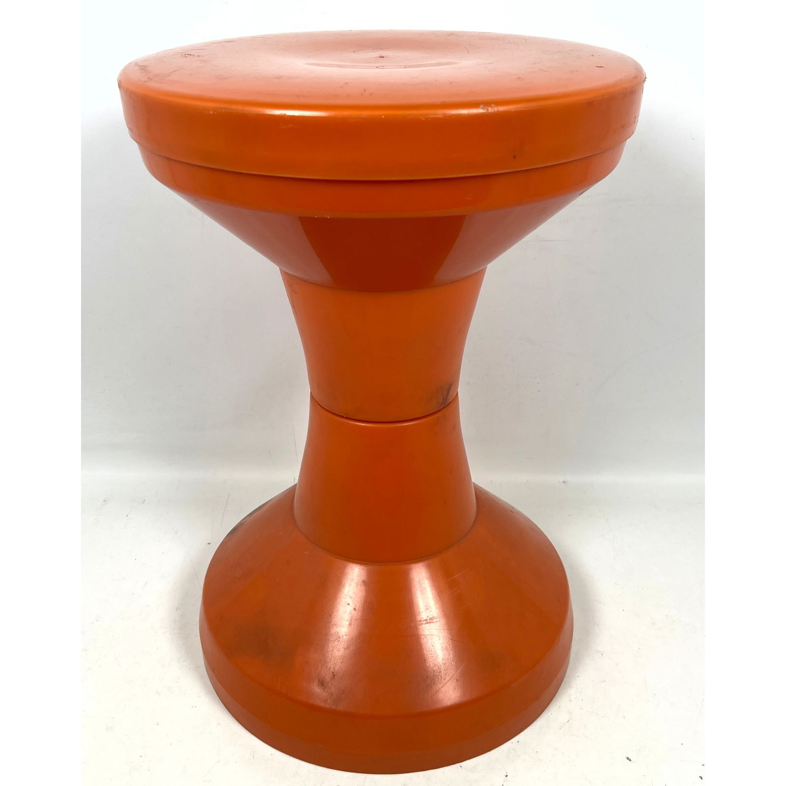 Danish Modern Orange Molded Plastic Stool. Corseted Pedestal Form. Similar to Tam Tam Stool. Marked: Danish Modern Orange Molded Plastic Stool. Corseted Pedestal Form. Similar to Tam Tam Stool. Marked Denmark. Dimensions: Height: 18 inches, Width: 12.5 inches, Depth: 12.5 inches. ---
