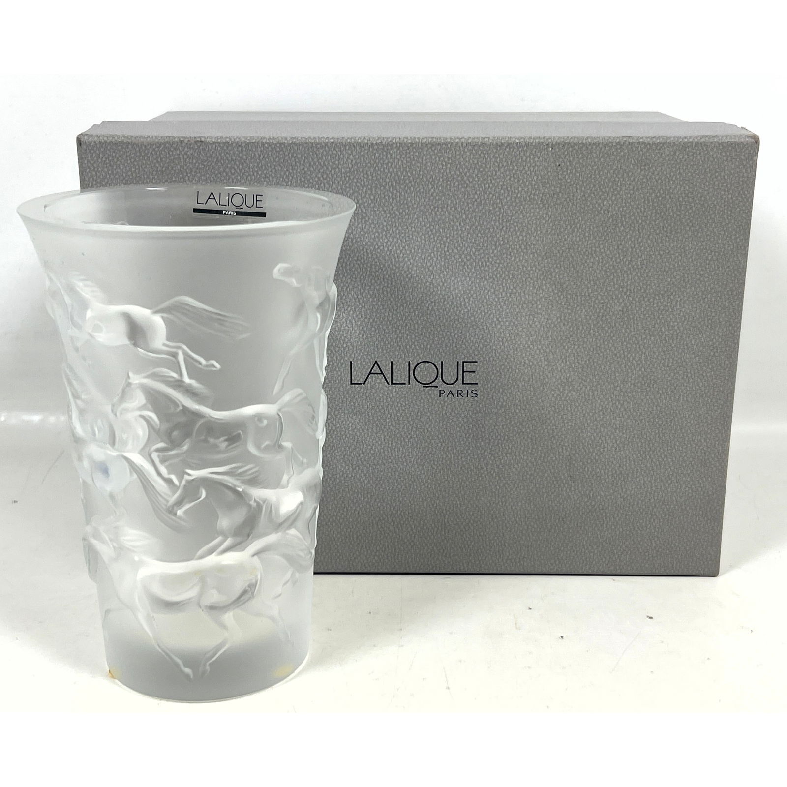 LALIQUE France Frosted Crystal Mustang Vase. Trumpet form vase with relief design of running Mustang: LALIQUE France Frosted Crystal Mustang Vase. Trumpet form vase with relief design of running Mustangs in original box with card. Marked. Dimensions: Height: 7 inches, Width: 4.75 inches, Depth: 4.75 i