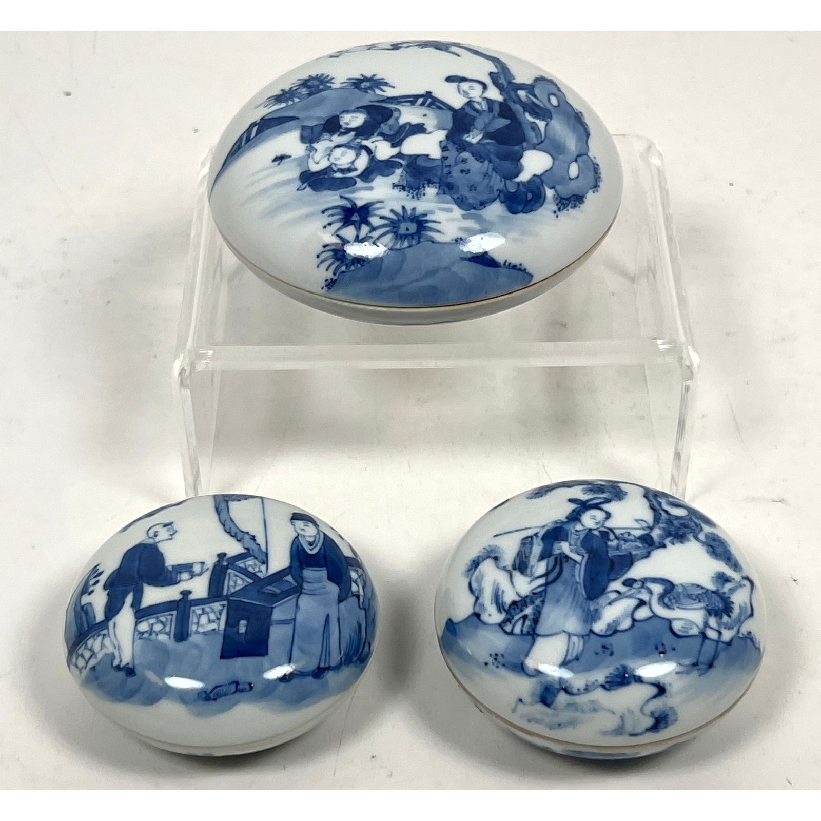 3pcs Chinese blue and white porcelain lidded boxes of compressed circular form.: 3pcs Chinese blue and white porcelain lidded boxes of compressed circular form. Dimensions: Height: 1.25 inches, Width: 5 inches, Depth: 5 inches. ---