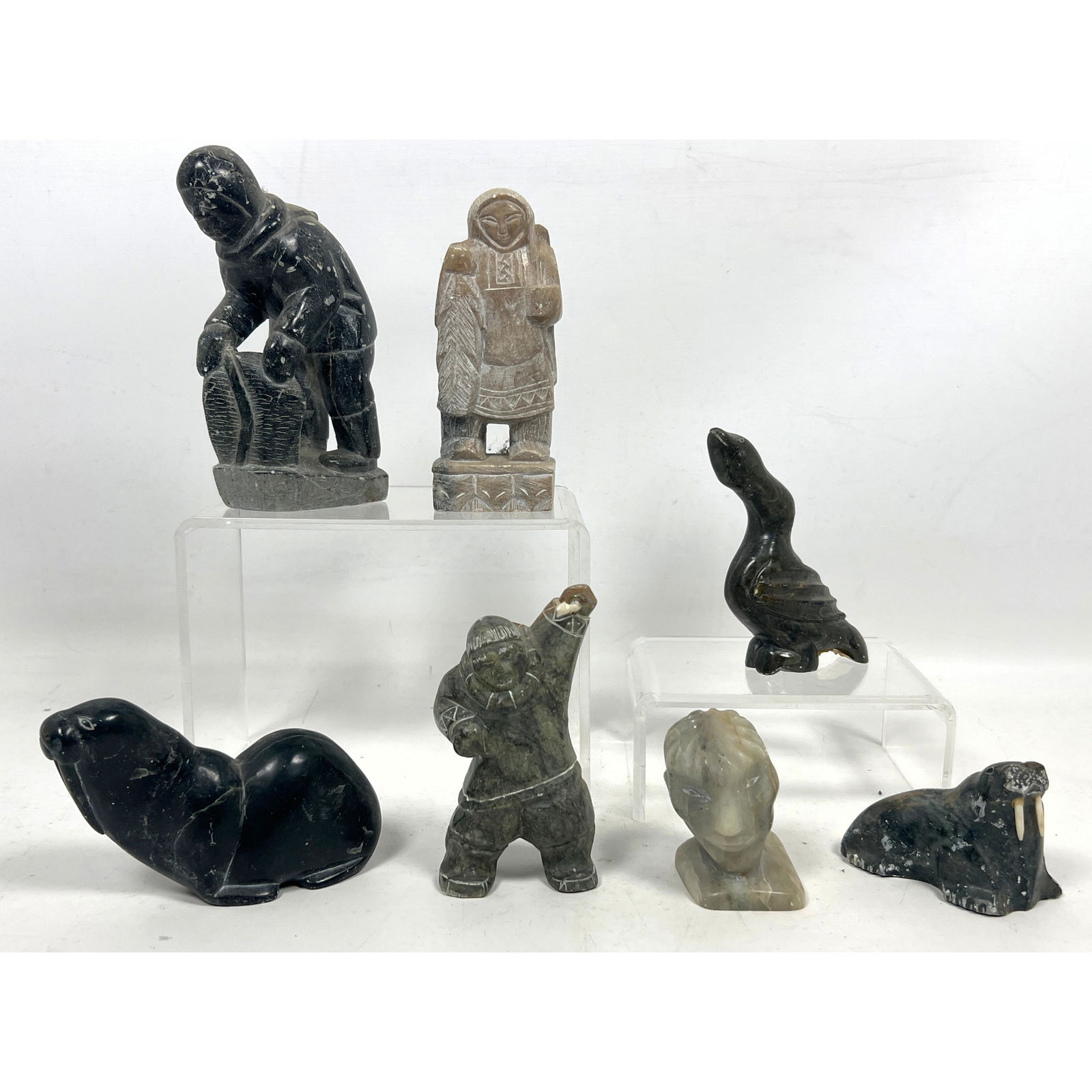Collection 7pc Eskimo or Inuit Carved Stone Figures. Some signed.: Collection 7pc Eskimo or Inuit Carved Stone Figures. Some signed. Dimensions: Height: 5.5 inches, Width: 2 inches, Depth: 1 inches. ---