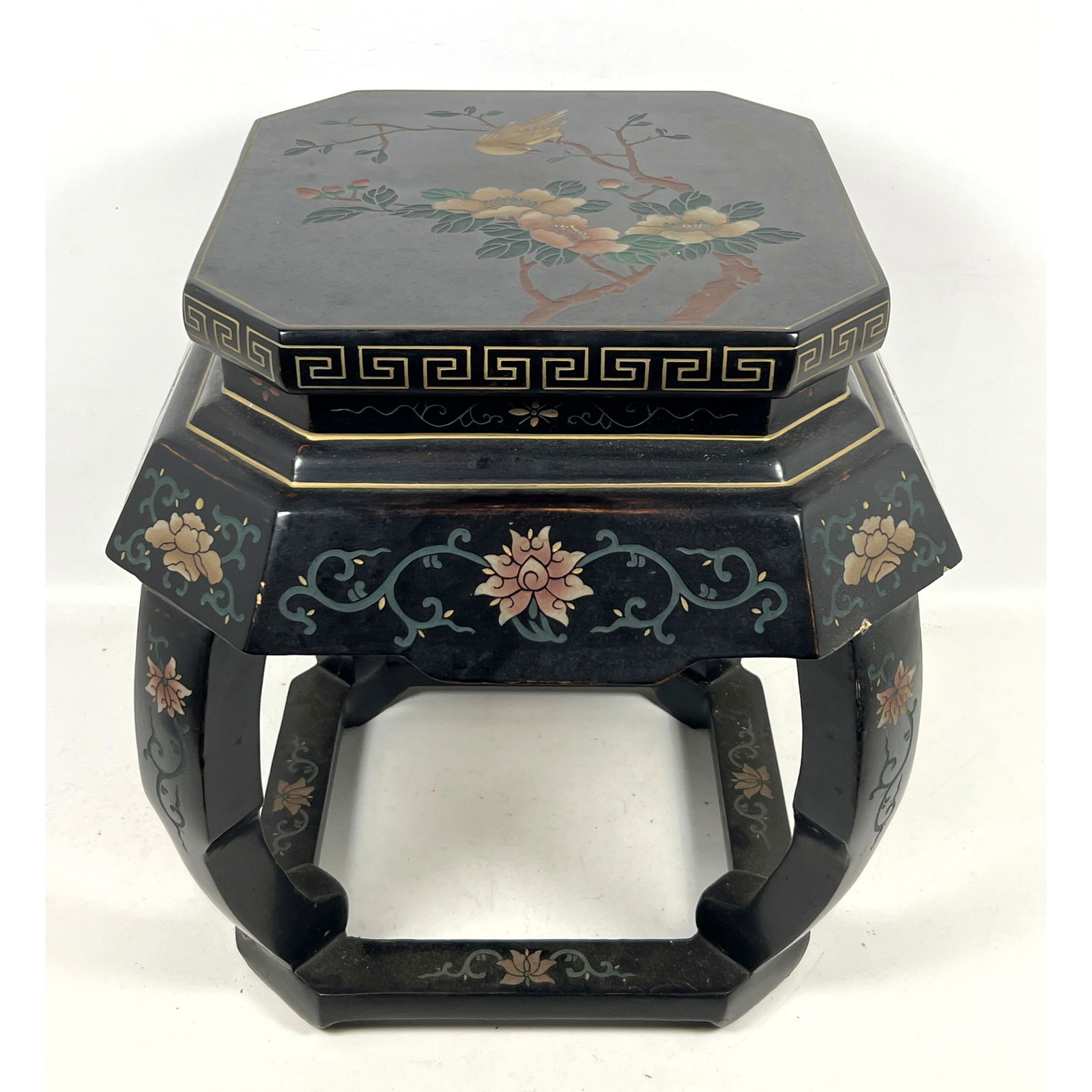 Asian black-lacquered wood stand or stool featuring an octagonal top and Chinoiserie-style decoratio: Asian black-lacquered wood stand or stool featuring an octagonal top and Chinoiserie-style decoration. Dimensions: Height: 19 inches, Width: 17 inches, Depth: 17 inches. ---