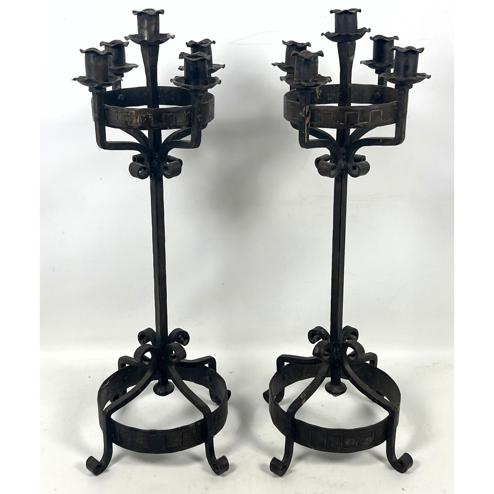 Pair of matching wrought iron candelabra featuring a dark, patinated finish. Gothic design.: Pair of matching wrought iron candelabra featuring a dark, patinated finish. Gothic design. Dimensions: Height: 24.25 inches, Width: 8.5 inches, Depth: 8.5 inches. ---