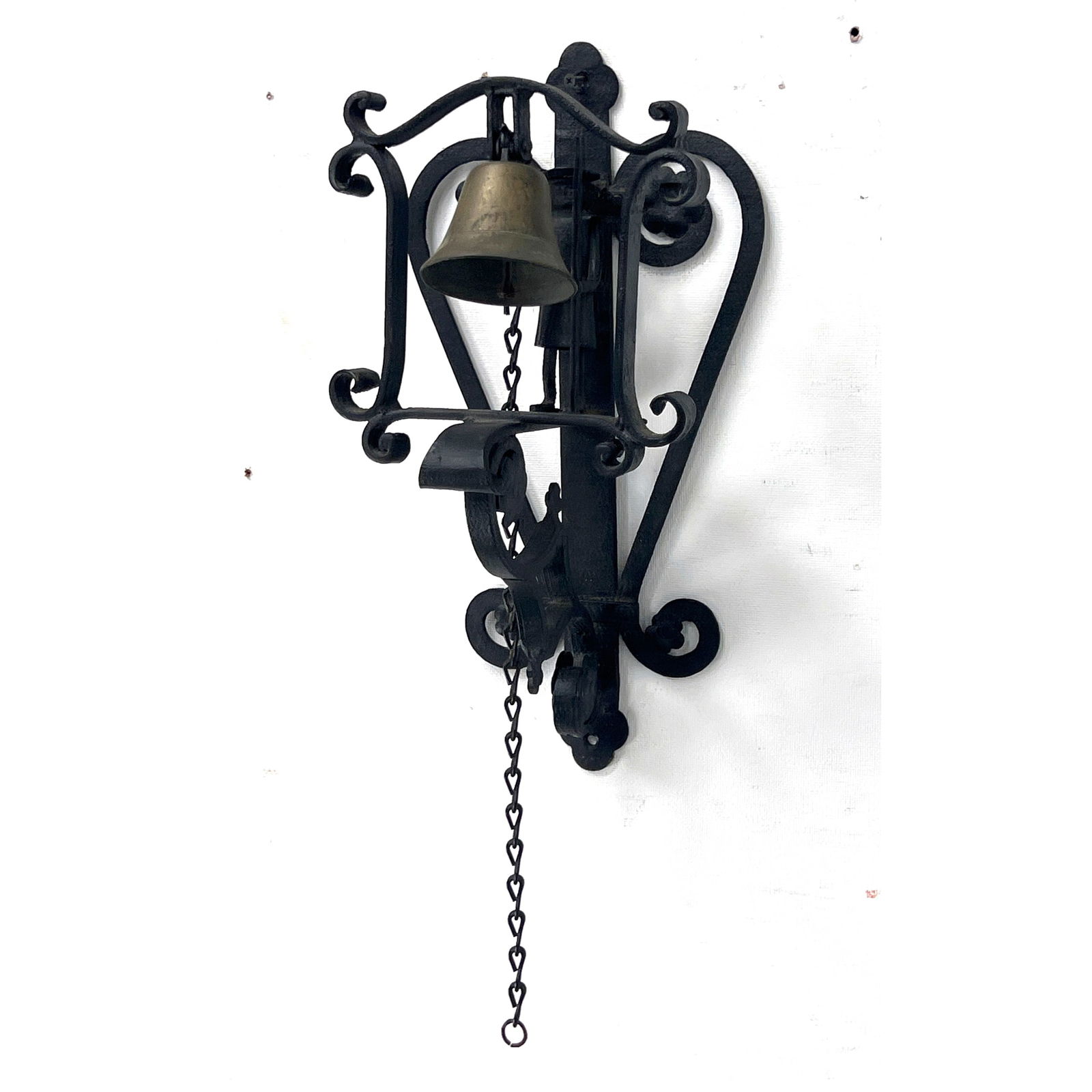 Figurative wall mounted bell. Wrought Iron Wall Mount has Figure with Hat and Spear. Brass Bell. Lar: Figurative wall mounted bell. Wrought Iron Wall Mount has Figure with Hat and Spear. Brass Bell. Large 18" Size. Metal Pull Chain. Dimensions: Height: 18 inches, Width: 9.5 inches, Depth: 9 inches. --