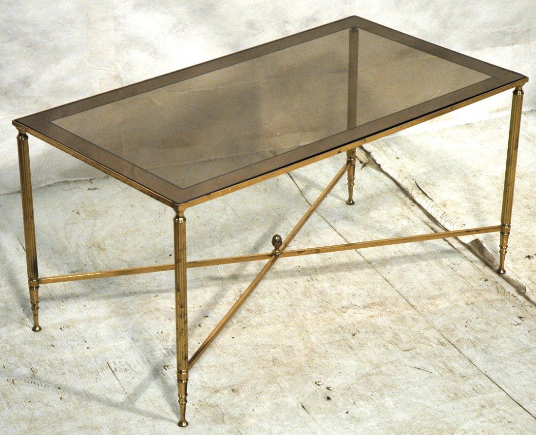 Brass Decorator Coffee Cocktail Table. Mirror Ban: Brass Decorator Coffee Cocktail Table. Mirror Banded glass top. "X" stretcher with pineapple finial. Regency.-- Dimensions: H: 17 inches: W: 33.75 inches: D: 18.75 inches ---