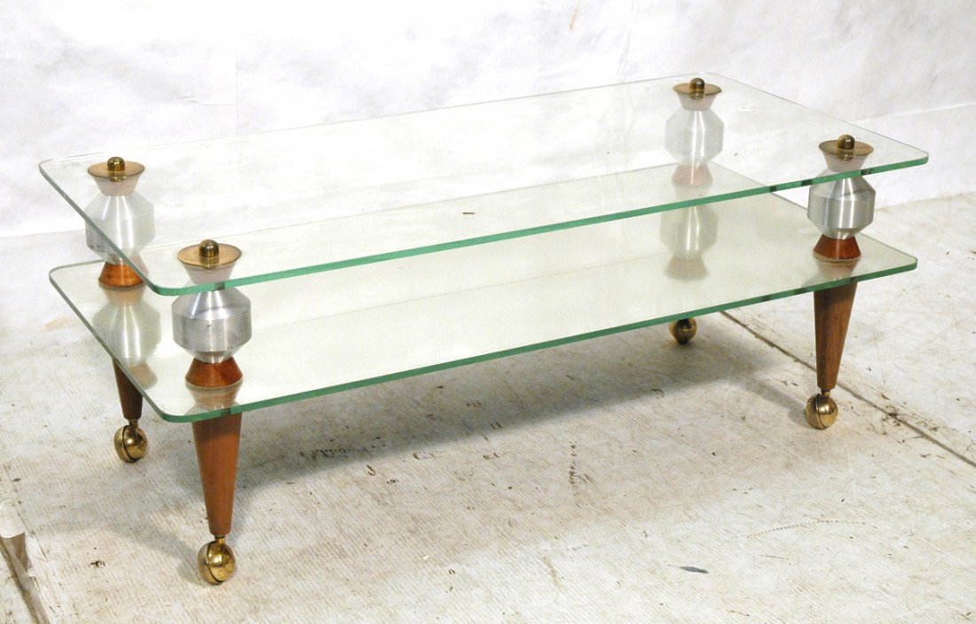 Glass & Aluminum 80's Modern Cocktail Table. Memp: Glass & Aluminum 80's Modern Cocktail Table. Memphis style 2 tier coffee table on casters. -- Dimensions: H: 15.75 inches: W: 42.25 inches: D: 20.25 inches ---