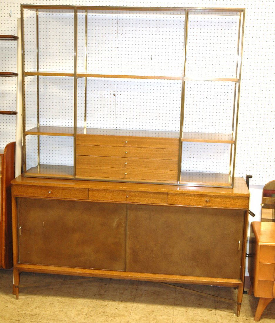 PAUL McCOBB Calvin Credenza with Shelf Etagere Di: PAUL McCOBB Calvin Credenza with Shelf Etagere Display Top. Top has brass rod frame with four drawers and shelves. Credenza sideboard base has two faux leather sliding doors. Brass "X" stretcher. 2 pc