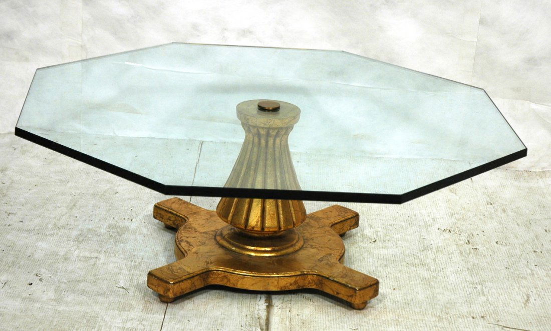 Octagonal Glass Gilt Wood Base Coffee Table. Ribb: Octagonal Glass Gilt Wood Base Coffee Table. Ribbed urn form on four armed base. 1" thick glass. -- Dimensions: H: 15.5 inches: W: 42 inches: D: 42 inches ---