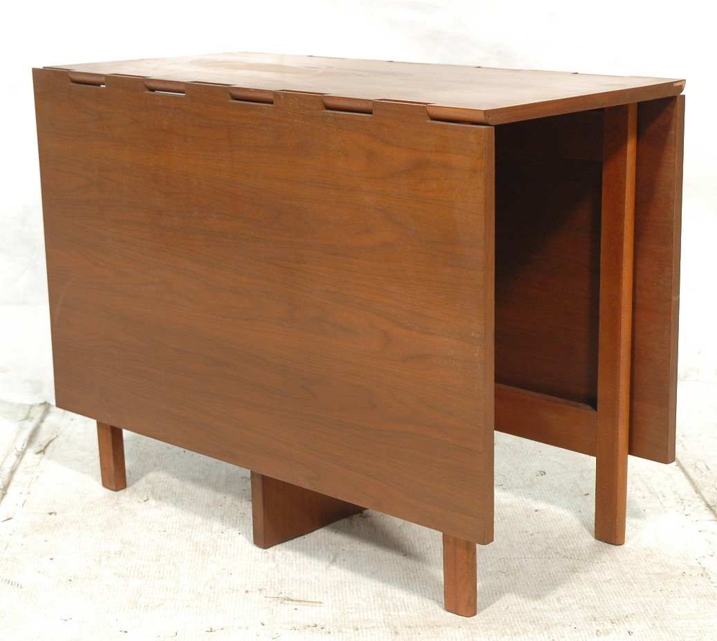 HERMAN MILLER Drop Side Dining Table. GEORGE NELS: HERMAN MILLER Drop Side Dining Table. GEORGE NELSON. Walnut frame. Four slanted legs. Aluminum tag. -- Dimensions: H: 30 inches: W: 18.75 inches: D: 40 inches ---