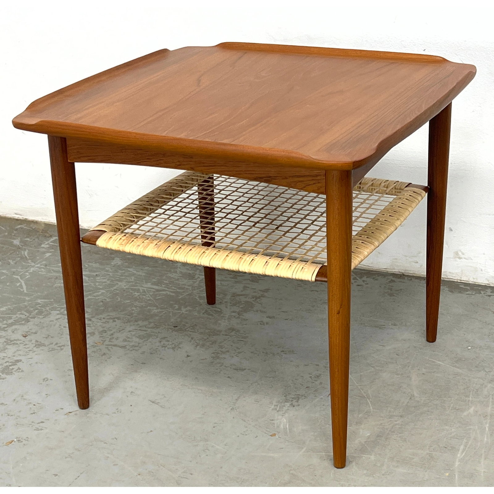 Poul Jensen for Selig Danish Modern Teak Occasional Table. Cane shelf table (fully restored includin: Poul Jensen for Selig Danish Modern Teak Occasional Table. Cane shelf table (fully restored including new cane shelf)1960's Denmark. Metal SELIG tag. Dimensions: Height: 20.5 inches, Width: 23.75 inch