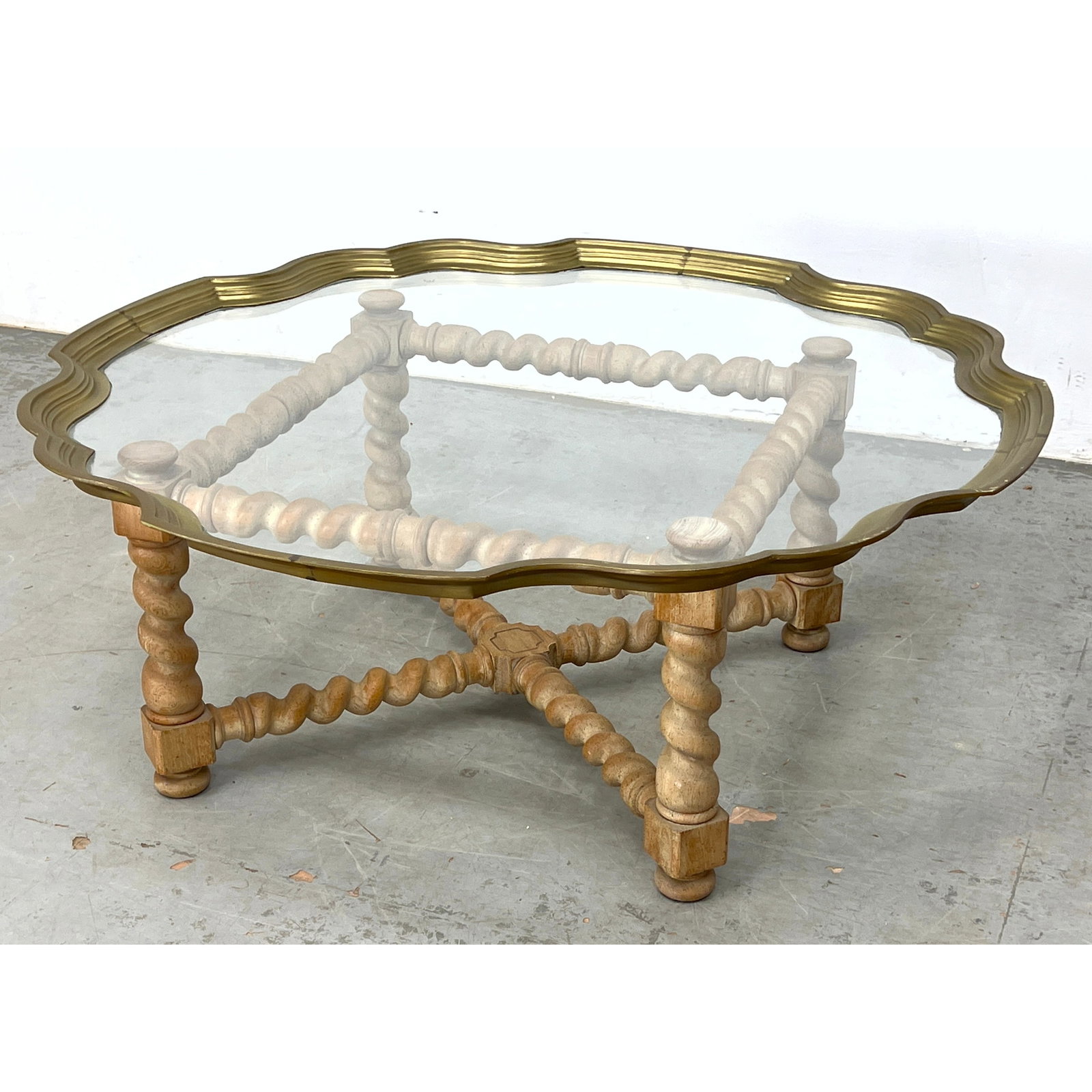 Baker Style Glass and Brass Top Coffee Table. Twisted cross stretcher.: Baker Style Glass and Brass Top Coffee Table. Twisted cross stretcher. Dimensions: Height: 17 inches, Width: 42.5 inches, Depth: 42.5 inches. ---